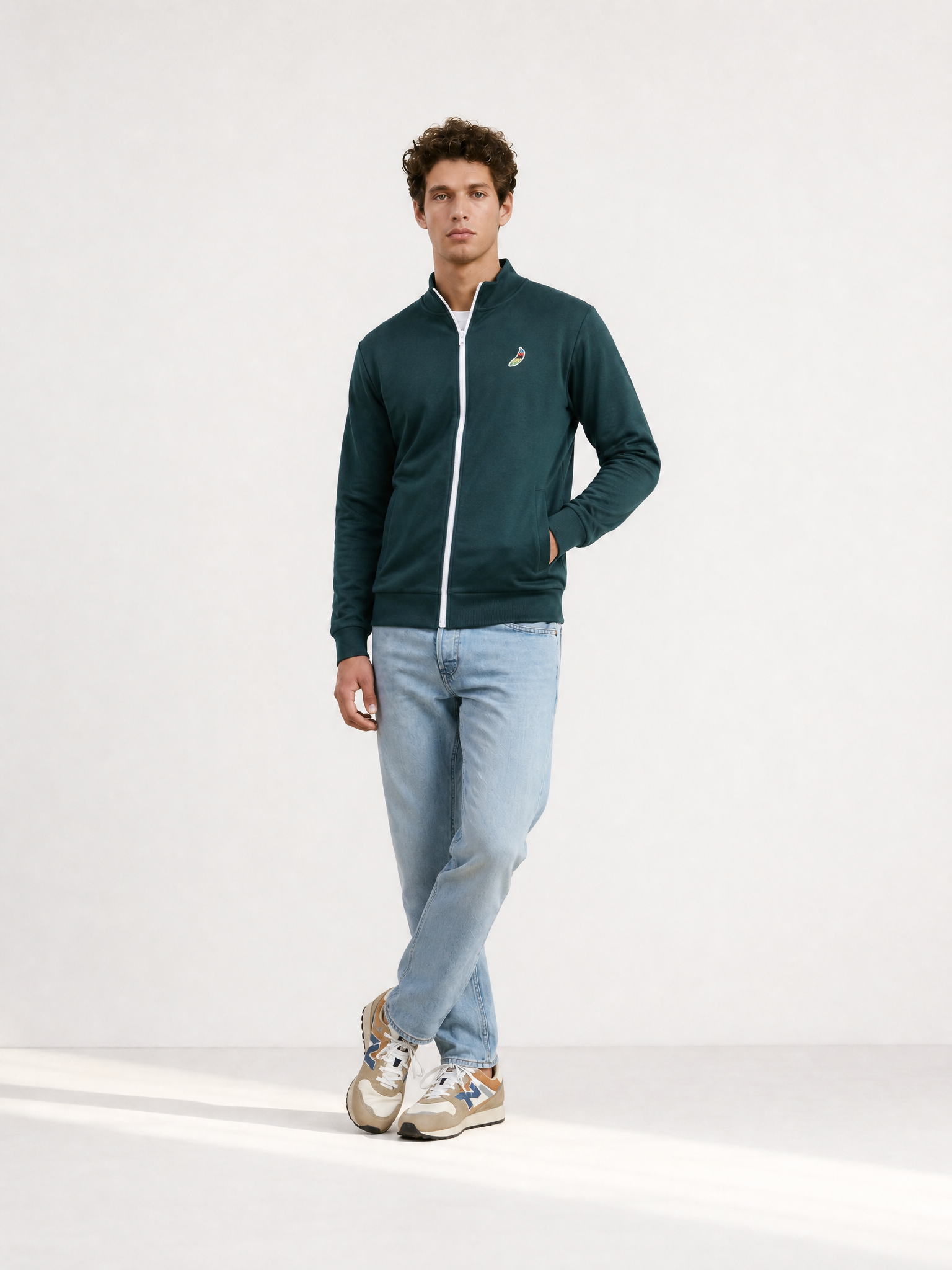 A model wearing the Food of Champions - Track Jacket - Atlantic Deep by La Machine Cycle Club.