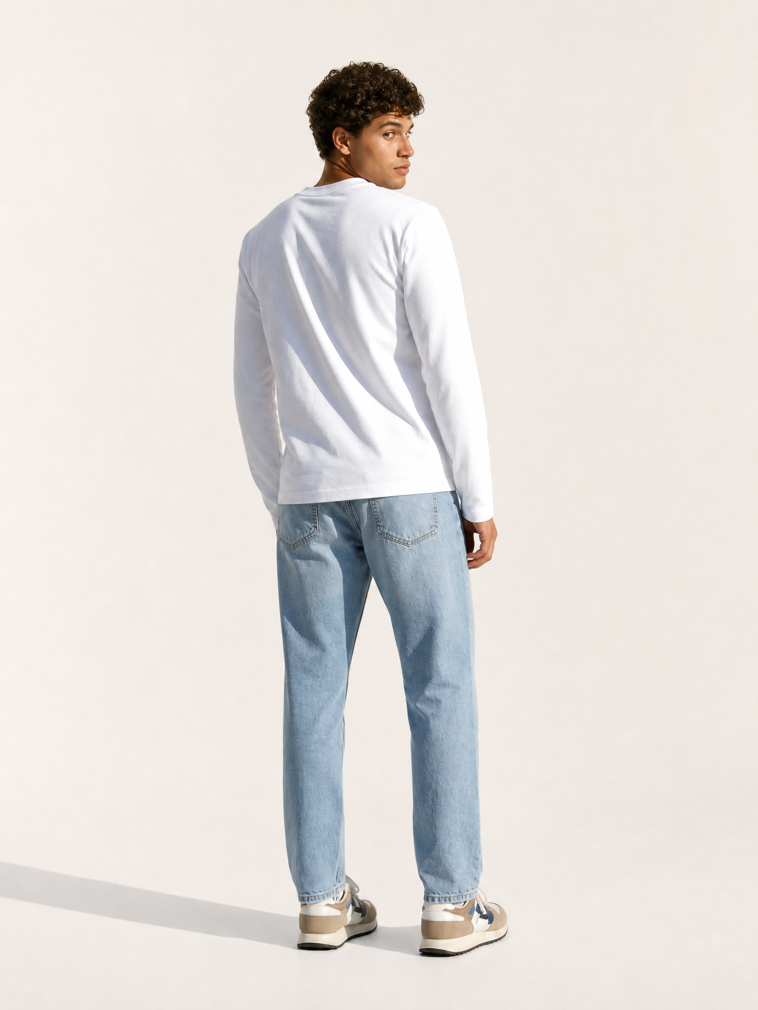 A model wearing the Food of Champions - Long Sleeve T-shirt - White by La Machine Cycle Club.