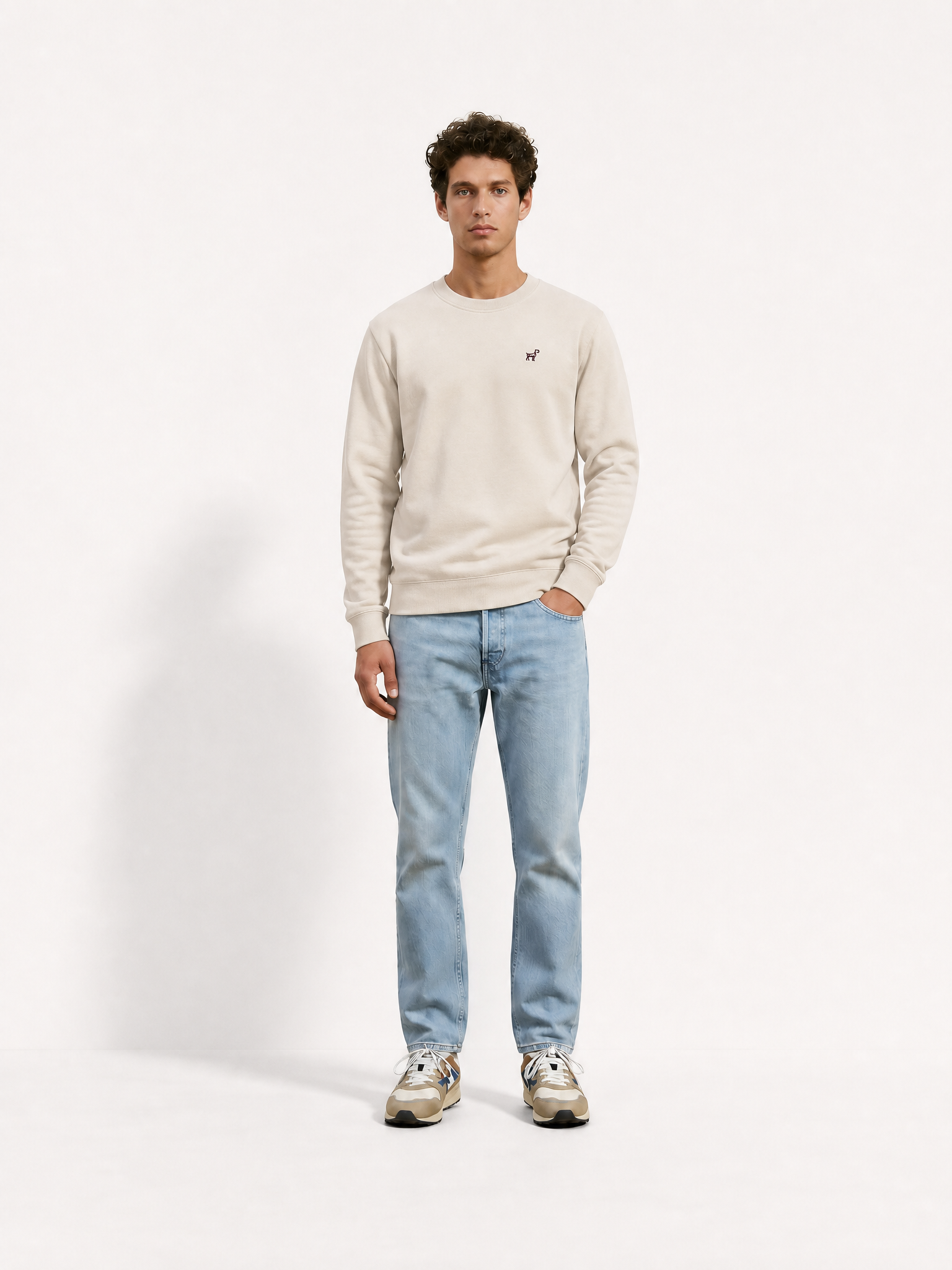 A model wearing the G.O.A.T. - Sweatshirt - Oyster Grey by La Machine Cycle Club.