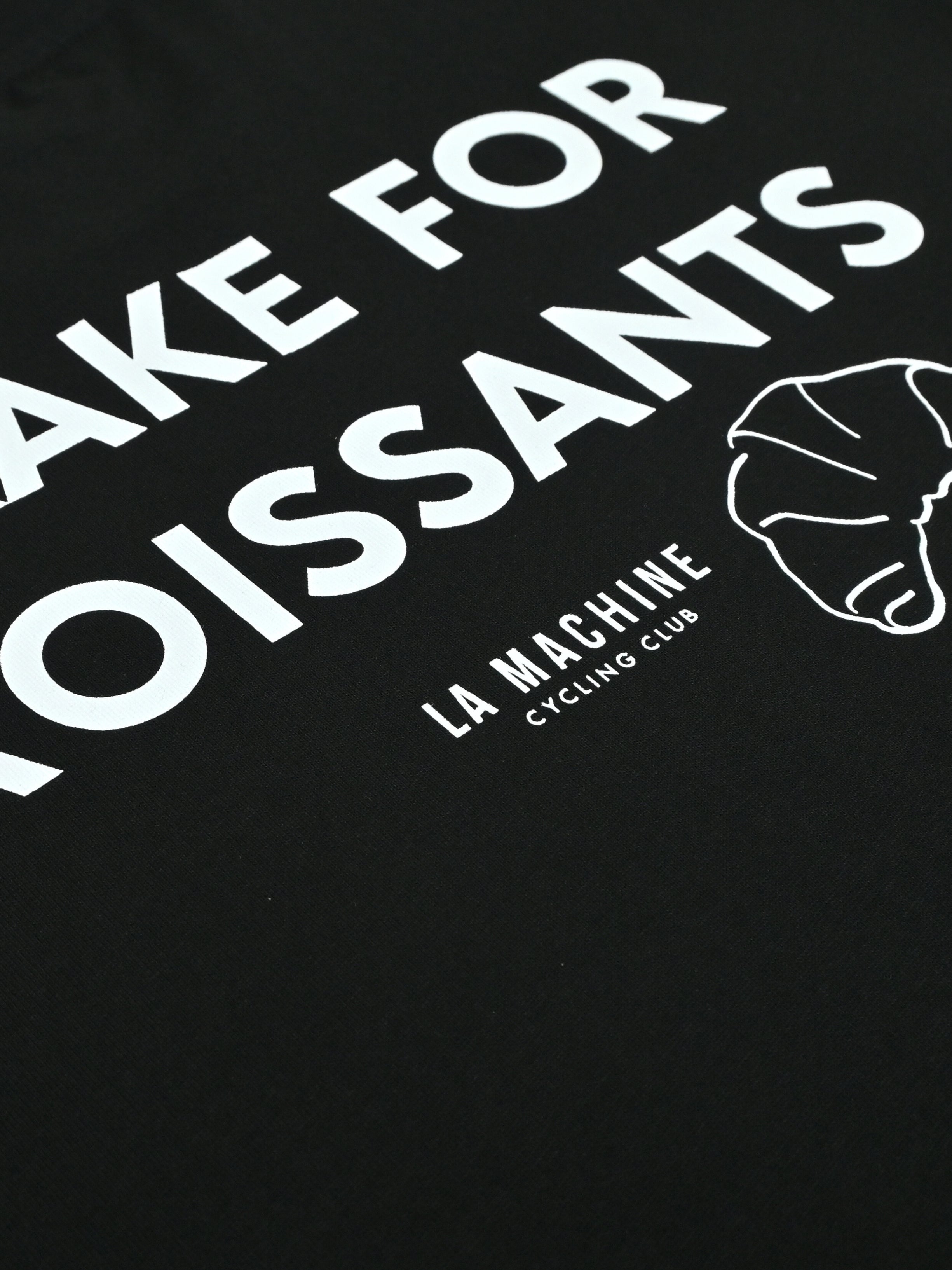 Detail view of the I Brake for Croissants - Loose Fit - T-shirt - Black by La Machine Cycle Club.