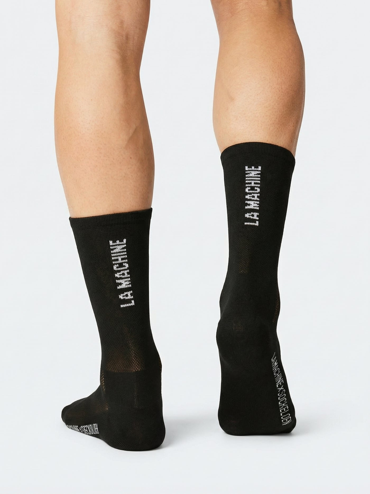 The La Machine Logo - Cycling Socks - Black - Merino by La Machine Cycle Club, shown from another angle.