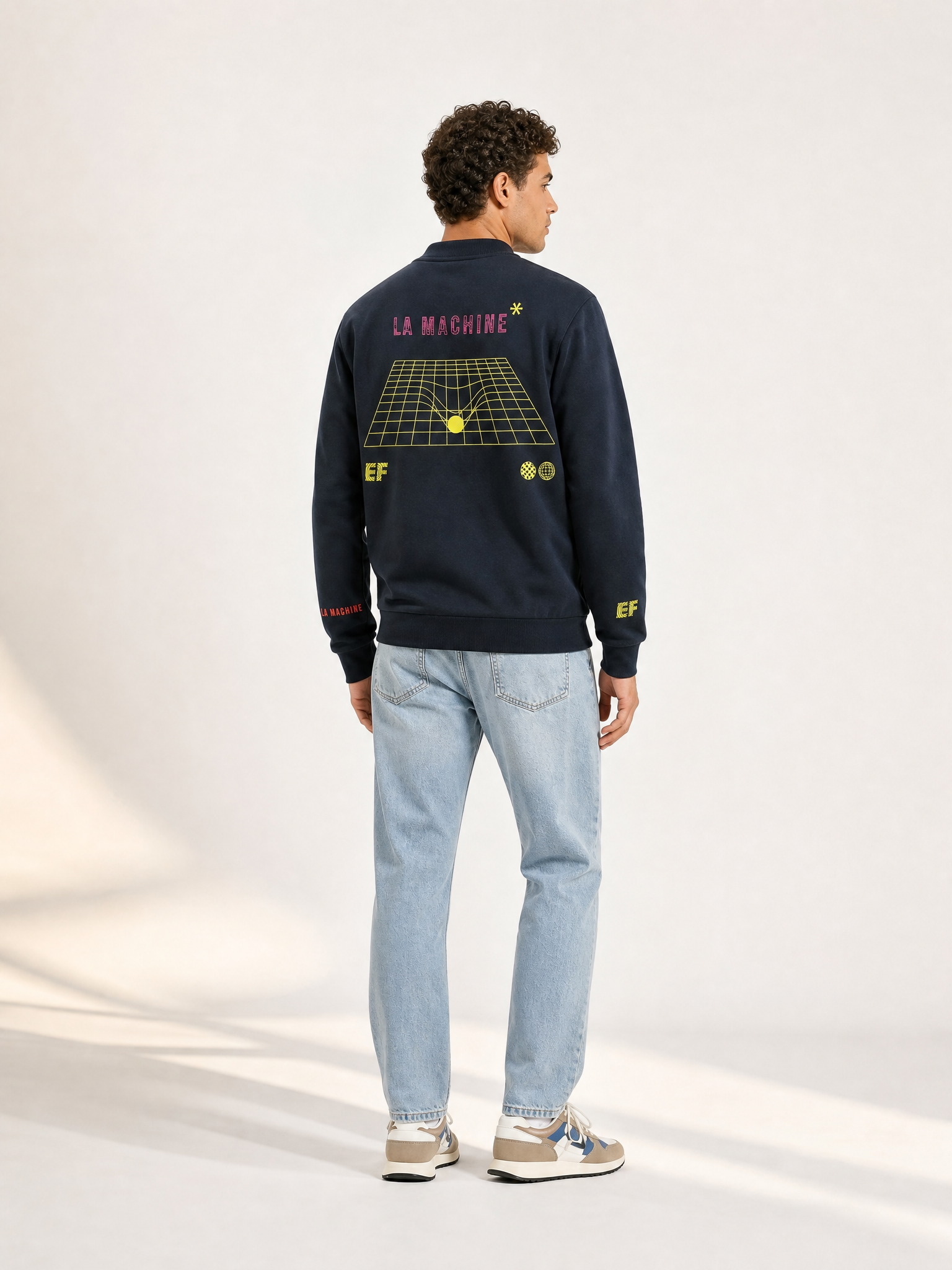 A model wearing the La Machine X EF Pro Cycling - Dimension - Sweatshirt - Dark Navy Blue by La Machine Cycle Club.