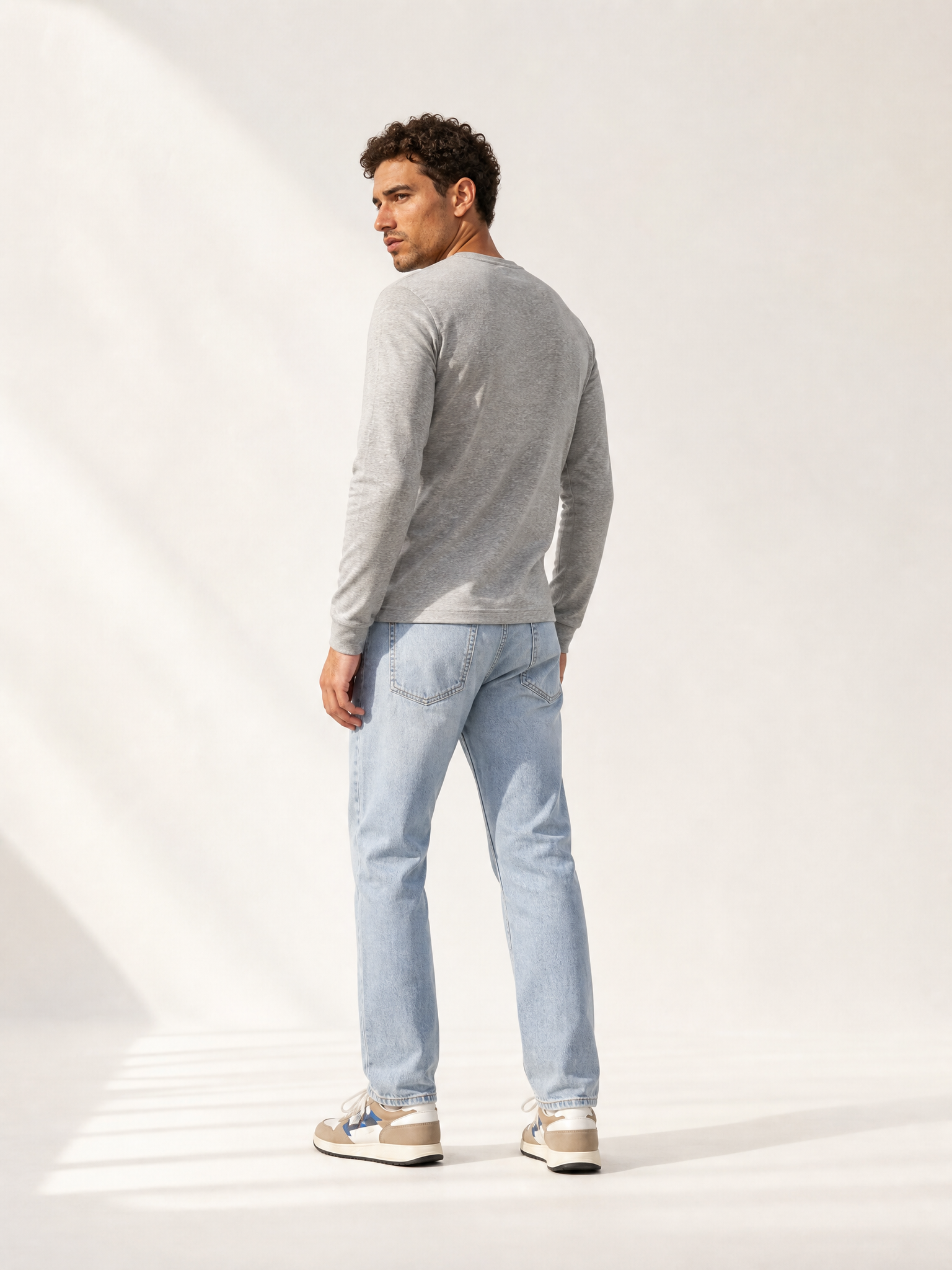 A model wearing the Le Pavé - Henley - Light Cobble Grey by La Machine Cycle Club.