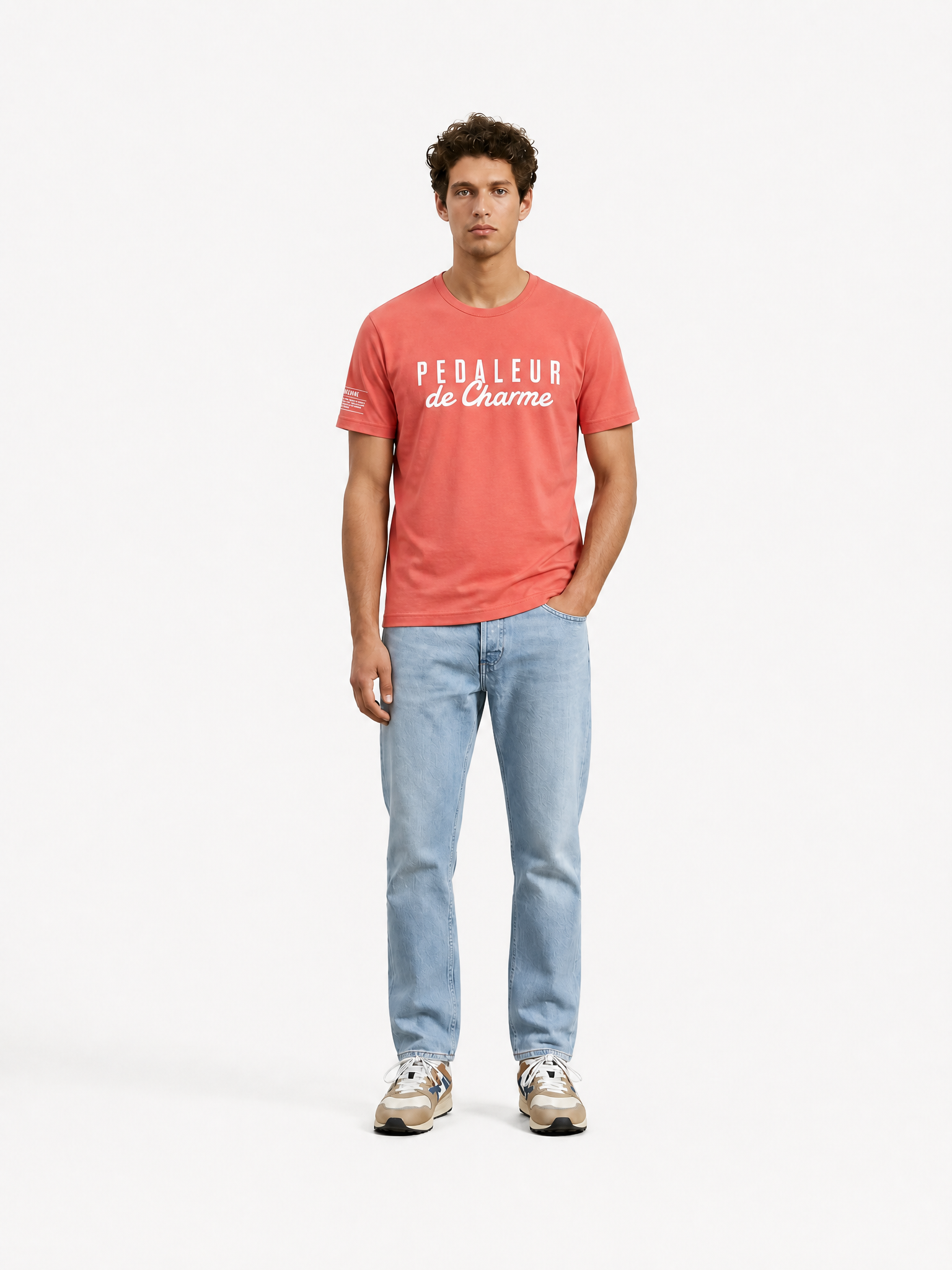 A model wearing the Pedaleur de Charme - T-shirt - Coral by La Machine Cycle Club.