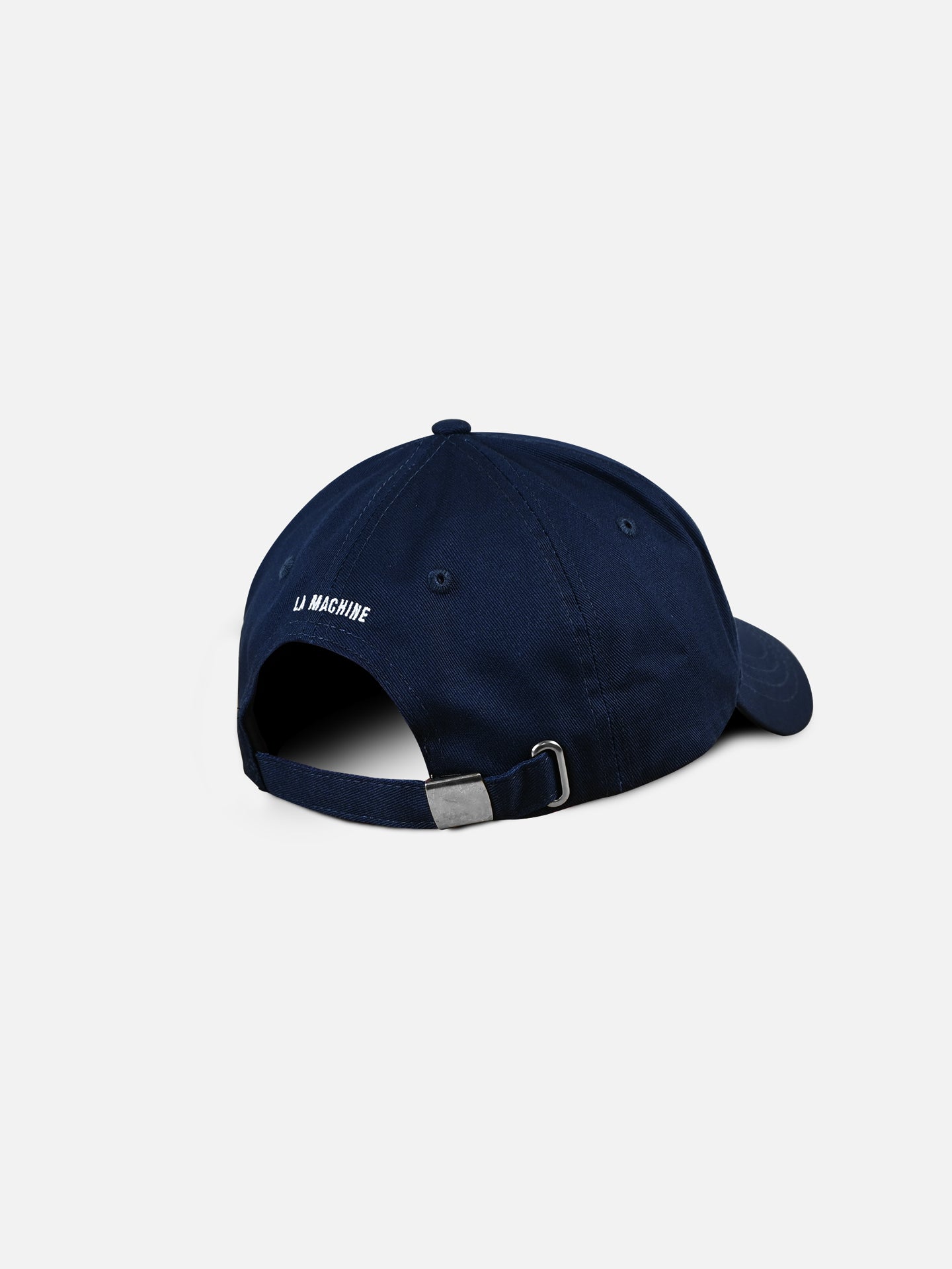 The Vai Vai - Casual Cap by La Machine Cycle Club is shown from the back, highlighting its dark blue color, adjustable strap with metal buckle, and white LA MACHINE text embroidered above the opening on a plain white background.