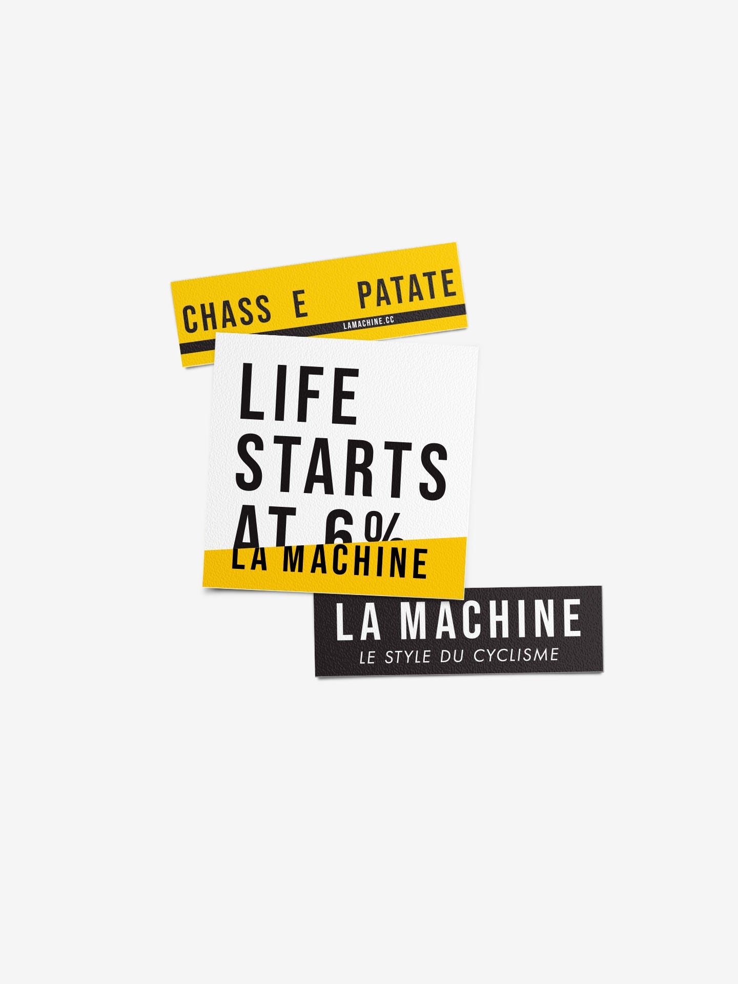 The La Machine Cycle Club Sticker Set - Yellow & Black - 3x features three bold rectangular vinyl stickers with CHASSE PATATE, LIFE STARTS AT 6% LA MACHINE, and LA MACHINE LE STYLE DU CYCLISME. Great for outdoor use.
