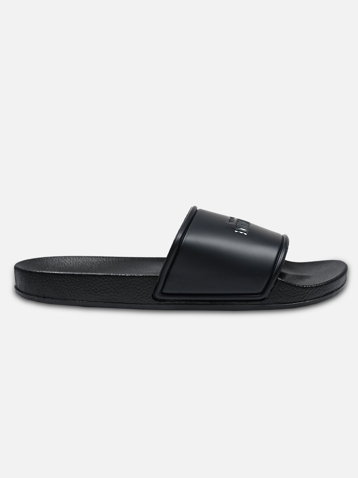 The La Machine Logo Slides/Slippers by La Machine Cycle Club are black slides with a thick, textured sole and wide top strap, ideal as post-ride footwear, shown in side profile on a plain white background.