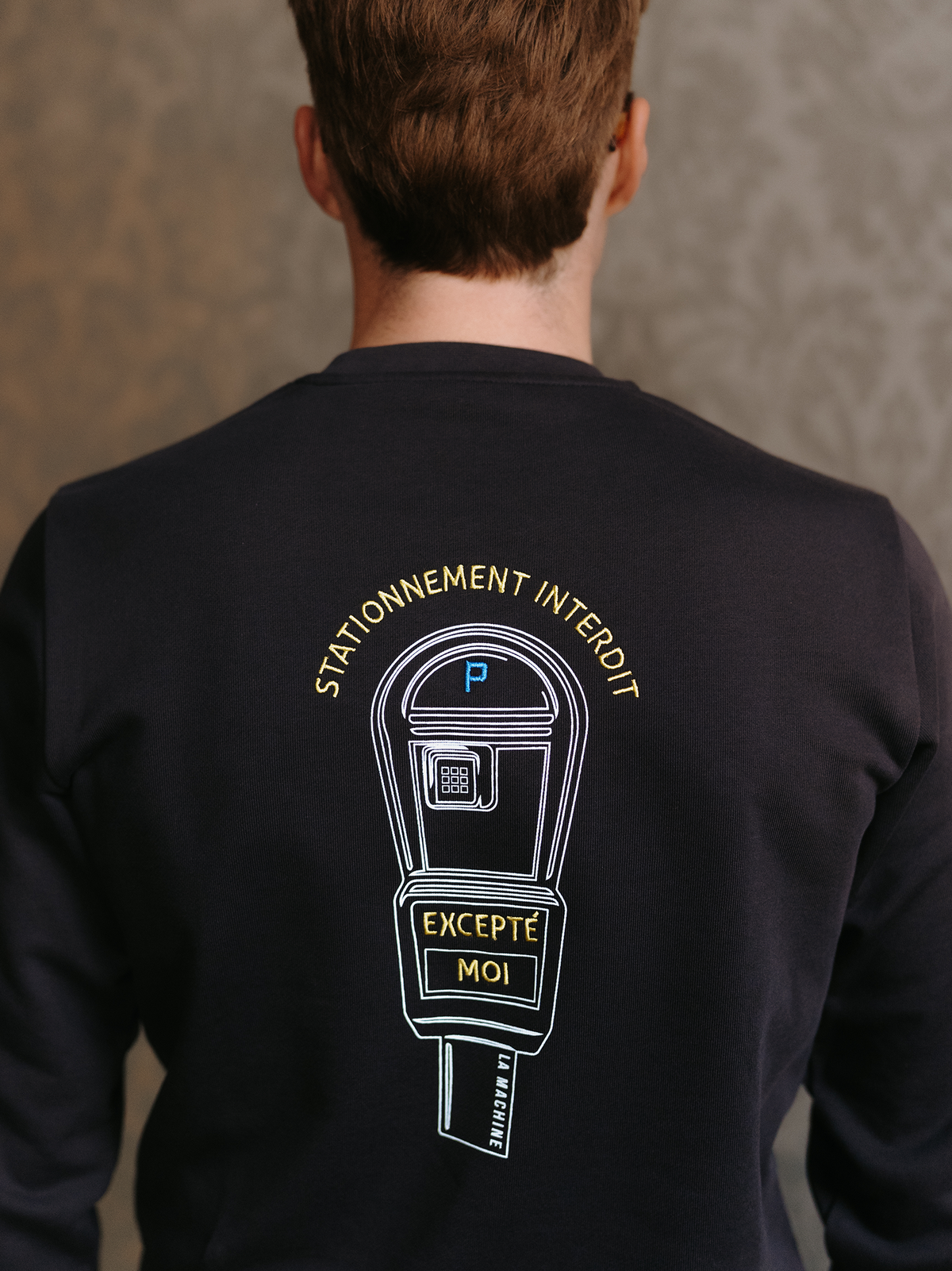 Close-up of the print on the Stationnement Interdit Sweatshirt in dark navy blue by La Machine.