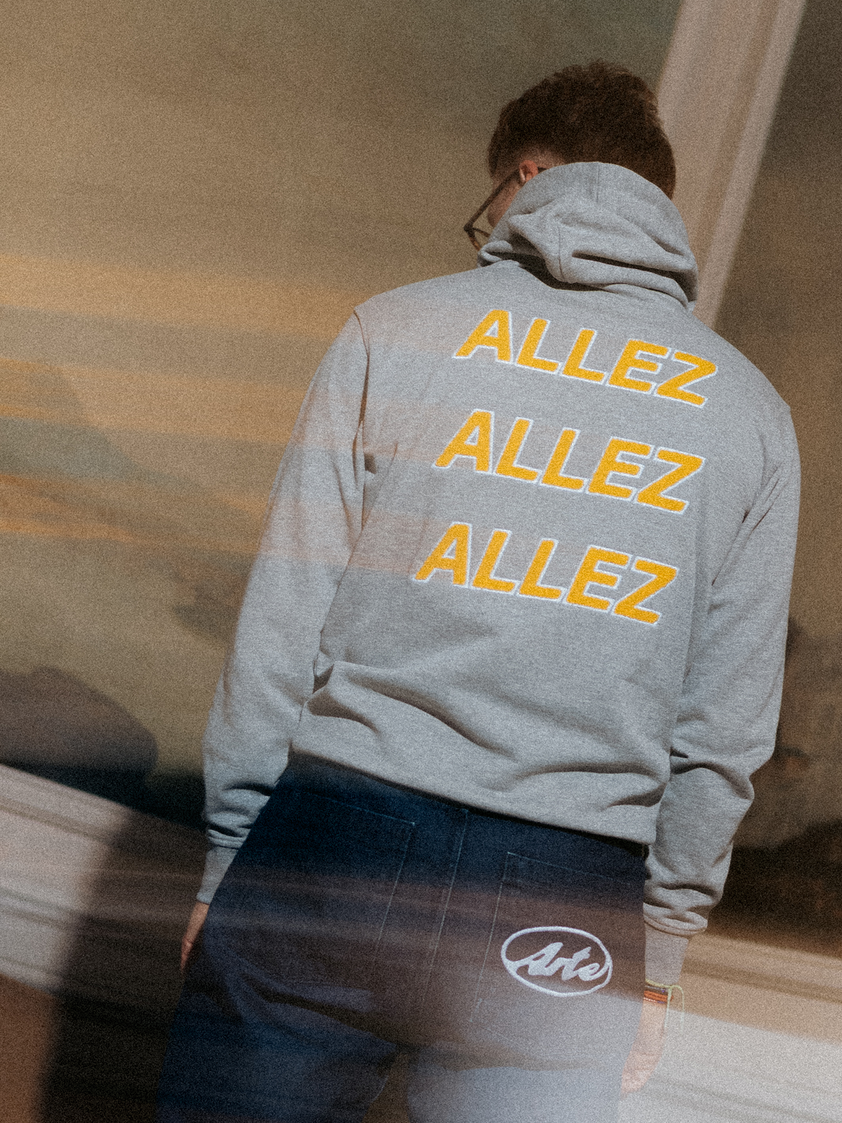 The Allez Allez Allez Hoodie in melange grey by La Machine, folded.