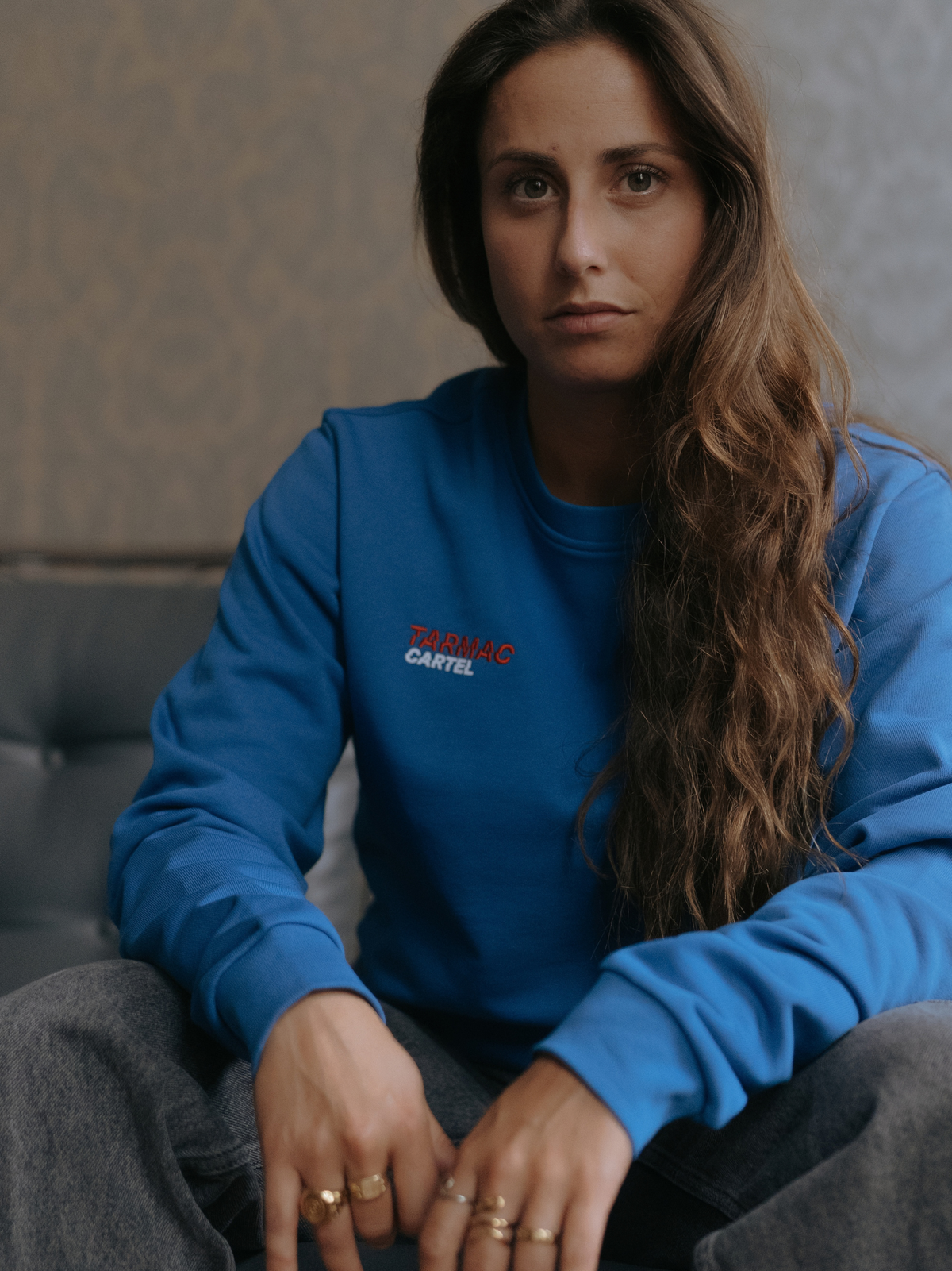 Close-up of the Tarmac Cartel print on the marine blue sweatshirt.