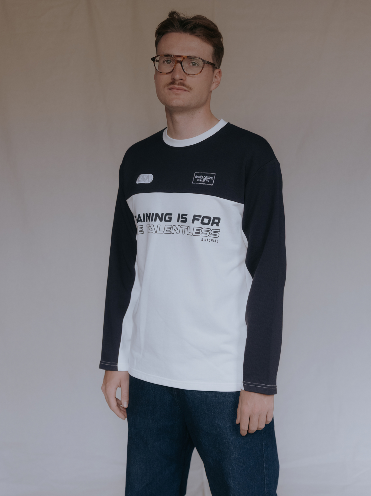 The Talentless Sweatshirt in dark navy blue and off white by La Machine, folded.