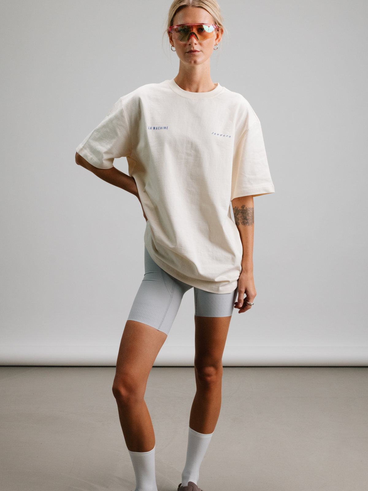 A model wearing the beige Icons T-shirt, shown from another angle.
