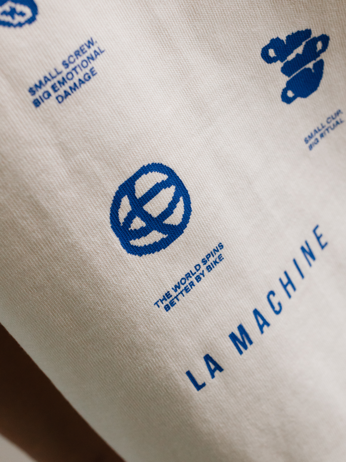 Close-up detail of the Icons graphic on the beige loose fit T-shirt.