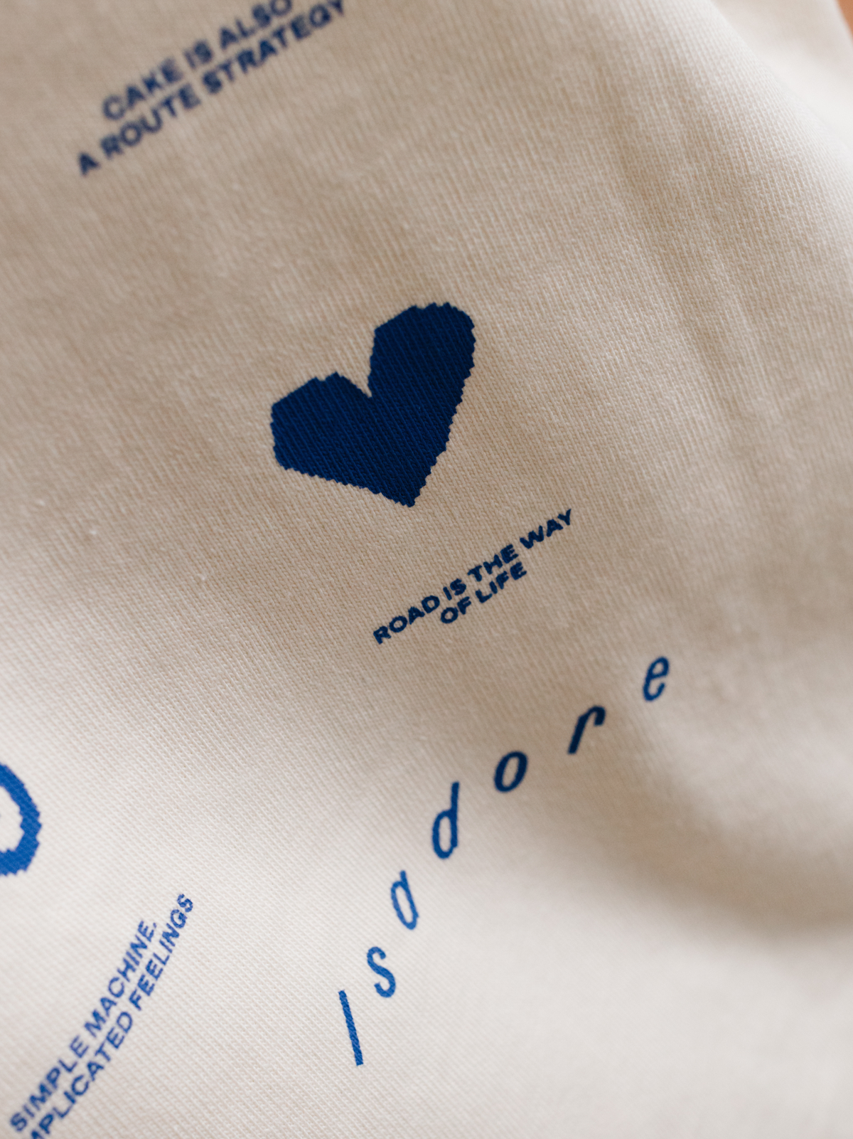 Back view of the beige La Machine x Isadore Icons T-shirt, showing the full print.