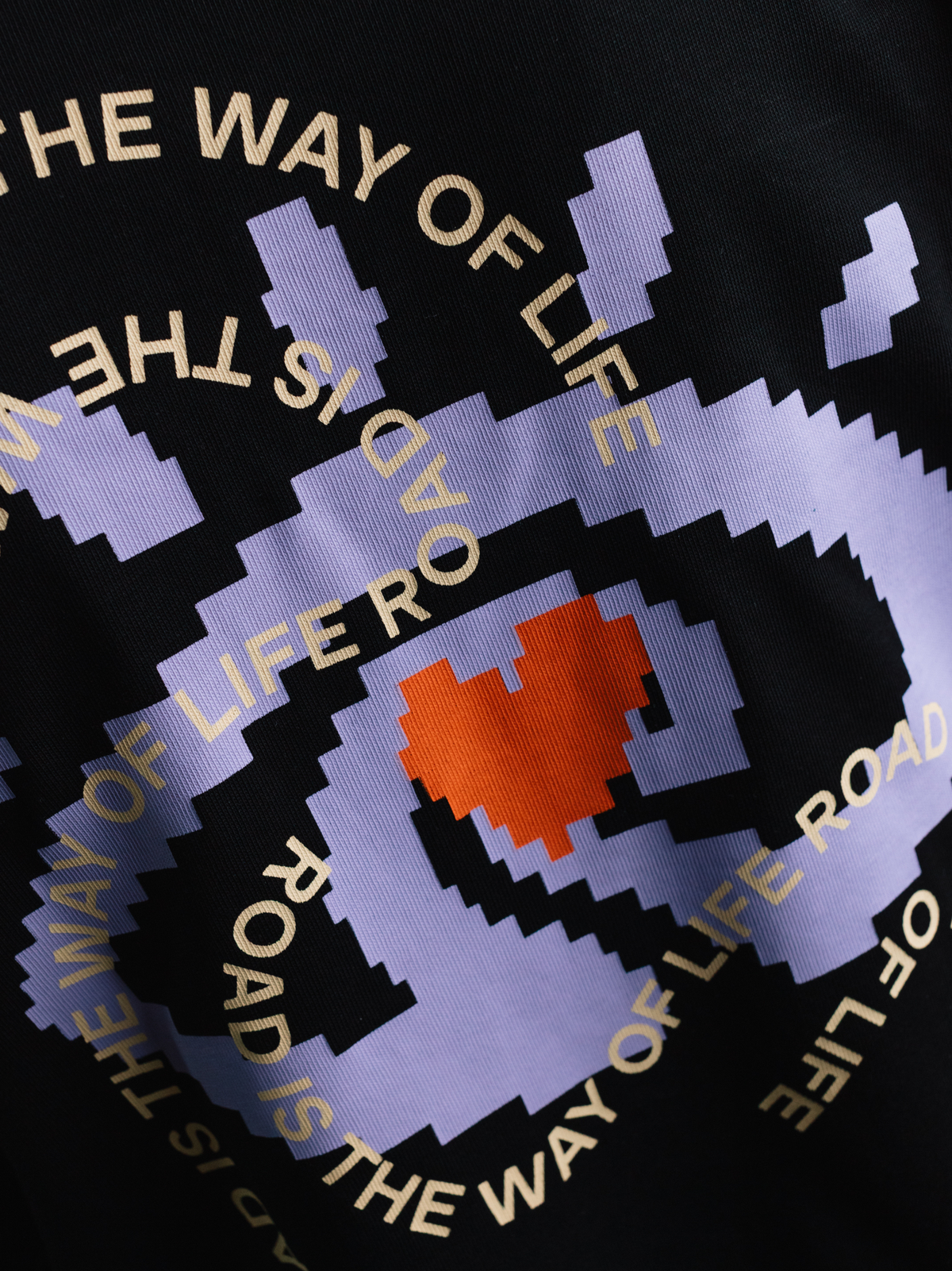 Detail shot of the neckline and hem on the black La Machine x Isadore Eye T-shirt.