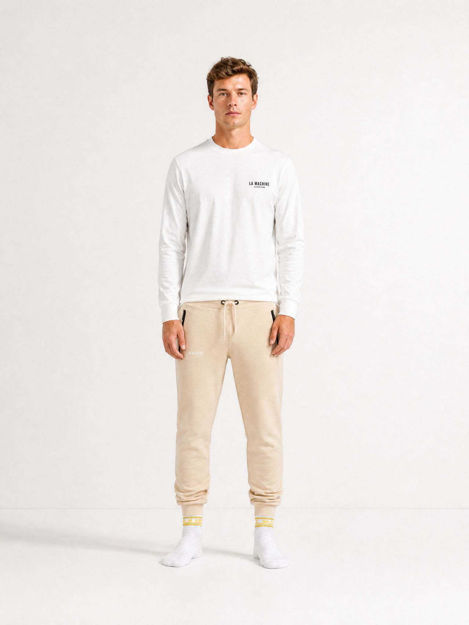 A model wearing the Beyond the bike - Sweatpants - Gravel Grey by La Machine Cycle Club.