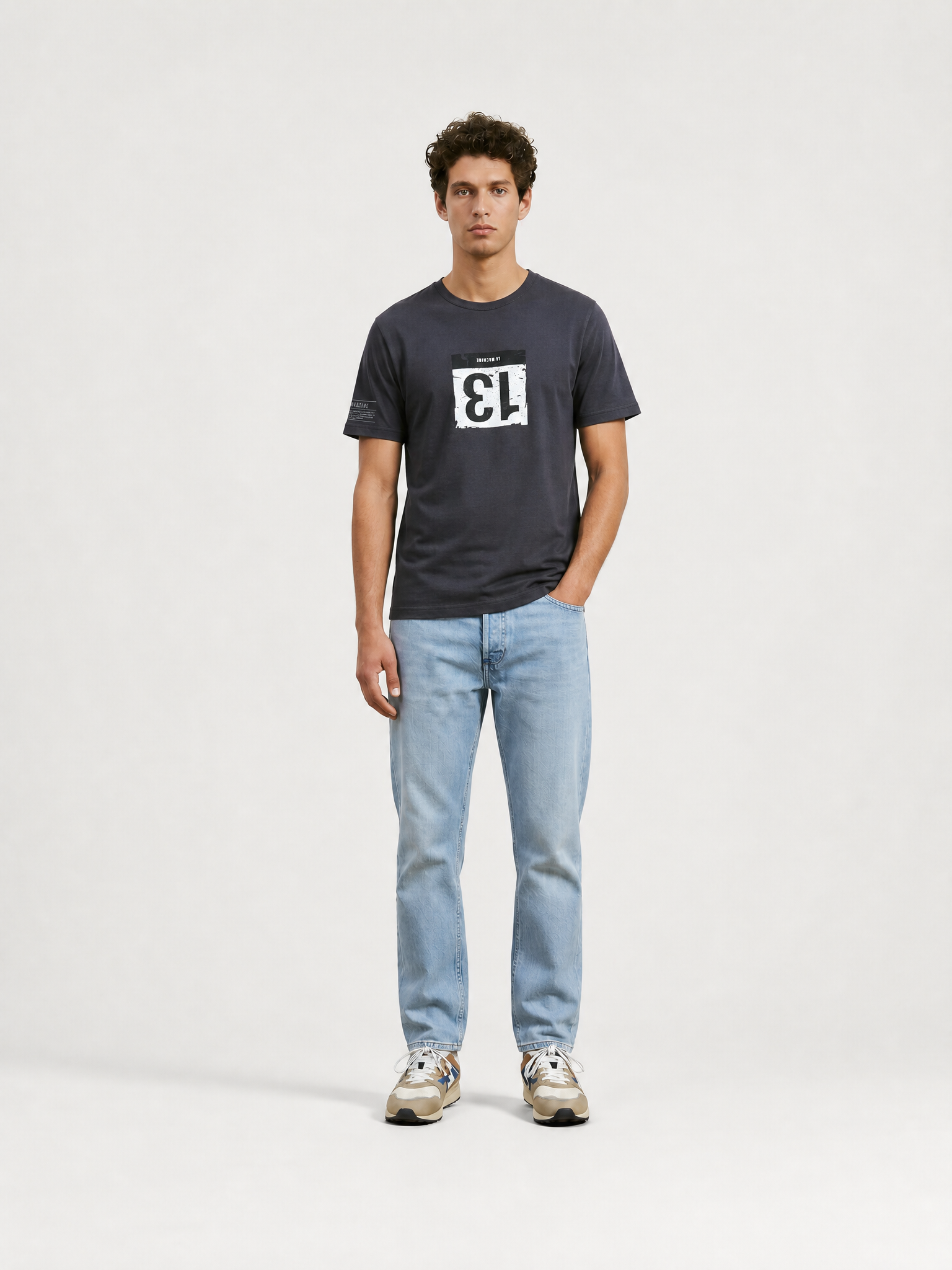 A model wearing the Bib Number 13 - T-shirt - Charcoal Teal by La Machine Cycle Club.