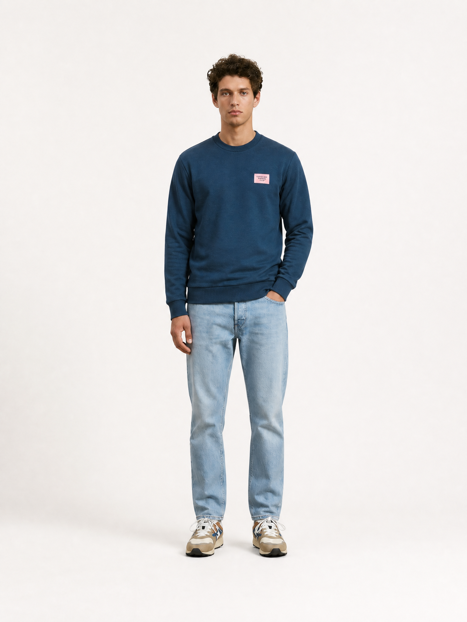 A model wearing the Coffee Ride Winners Club - Sweatshirt - Sailor Blue by La Machine Cycle Club.