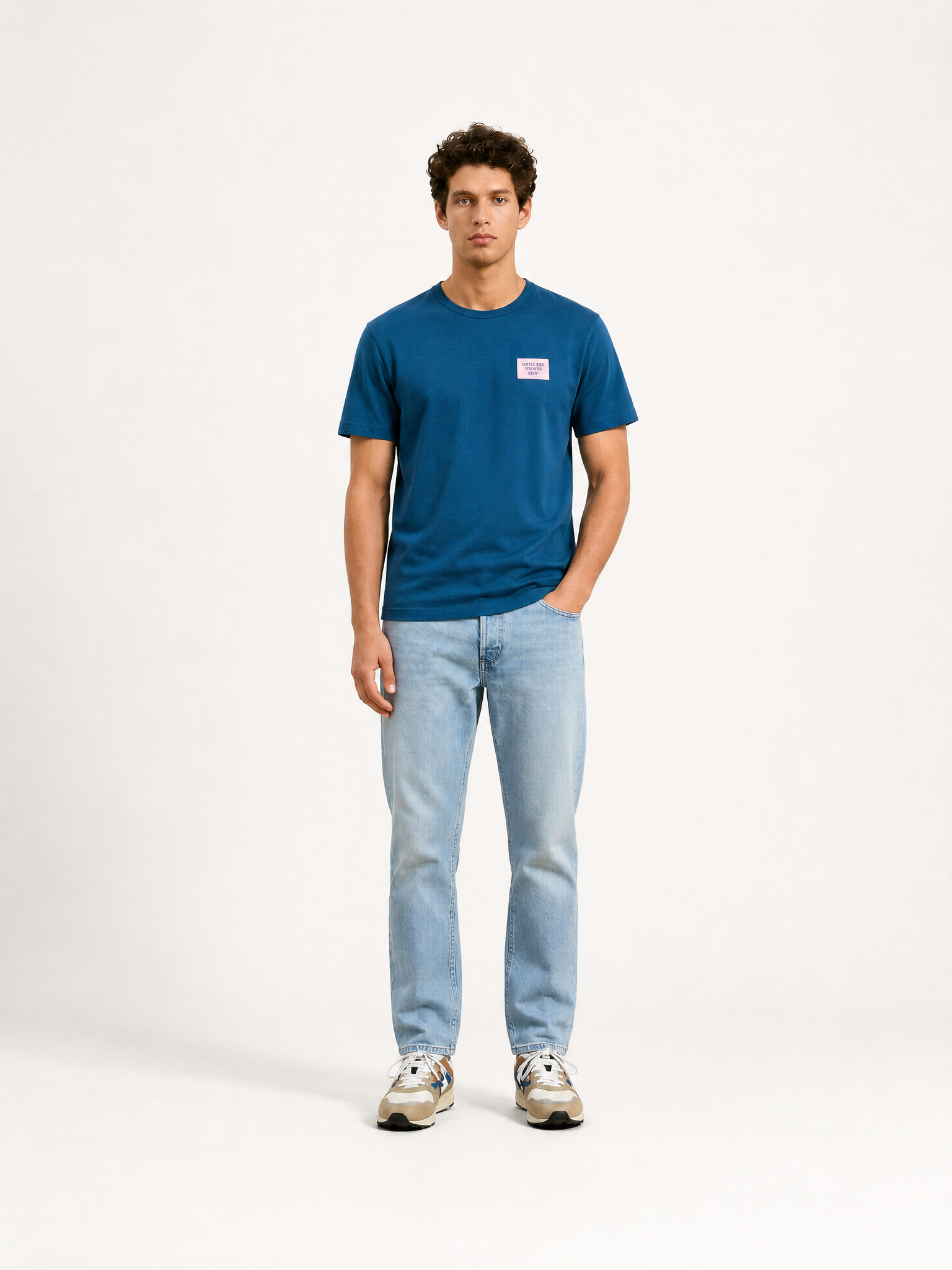 A model wearing the Coffee Ride Winners Club - T-shirt - Blue by La Machine Cycle Club.