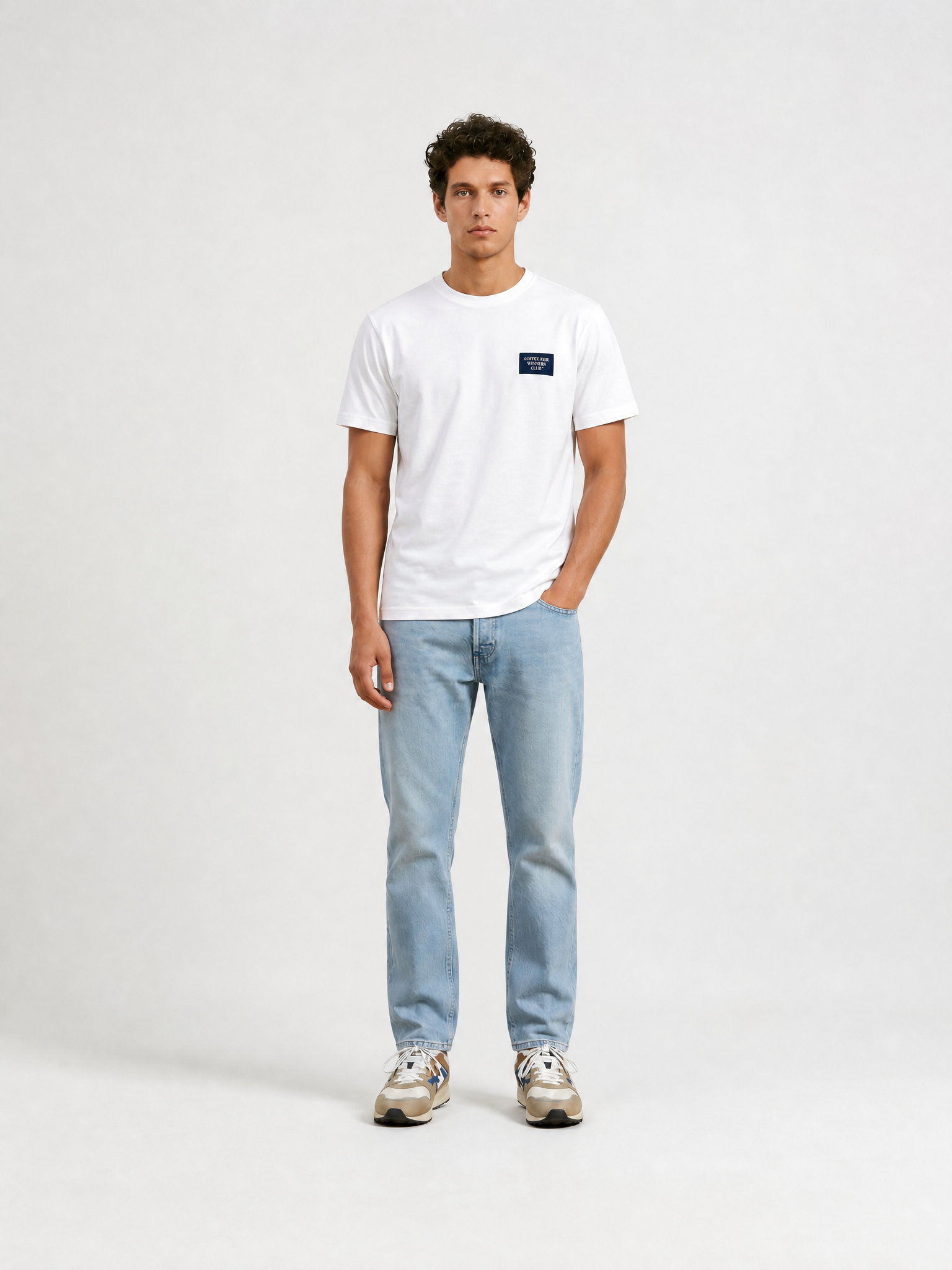 A model wearing the Coffee Ride Winners Club - T-shirt - White by La Machine Cycle Club.