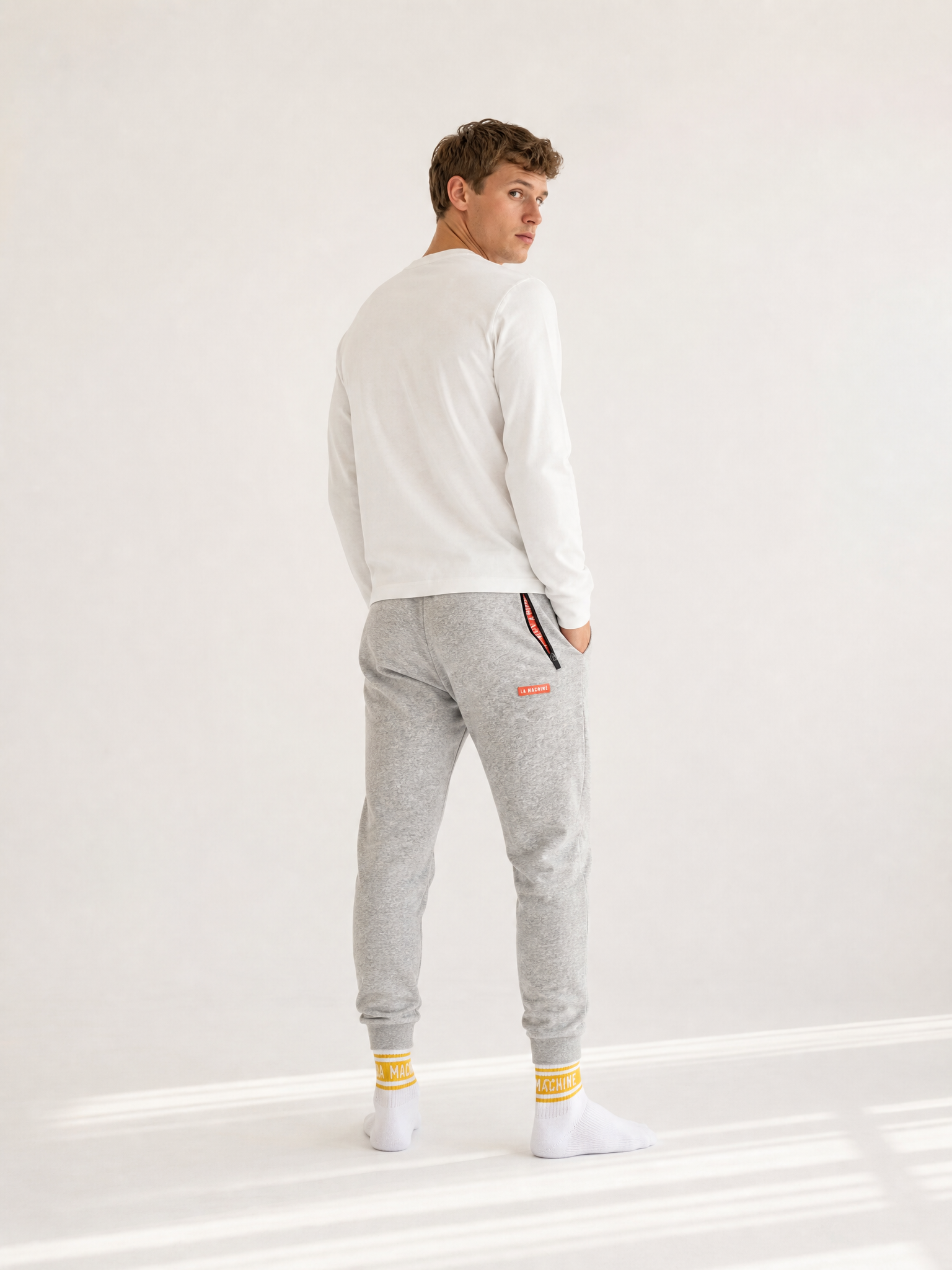 A model wearing the De Koersbroek - Sweatpants by La Machine Cycle Club.