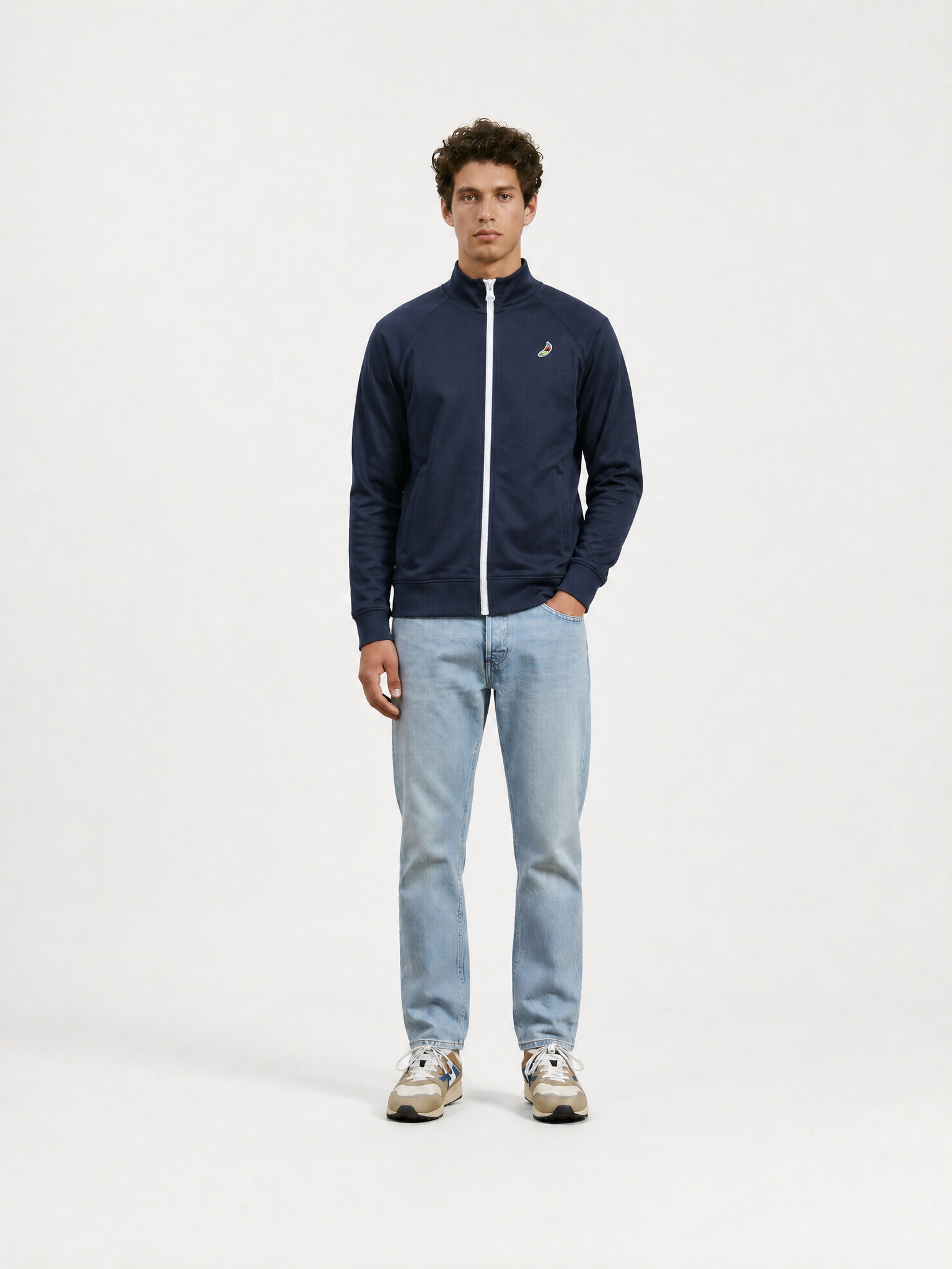 A model wearing the Food of Champions - Track Jacket - Dark Navy by La Machine Cycle Club.
