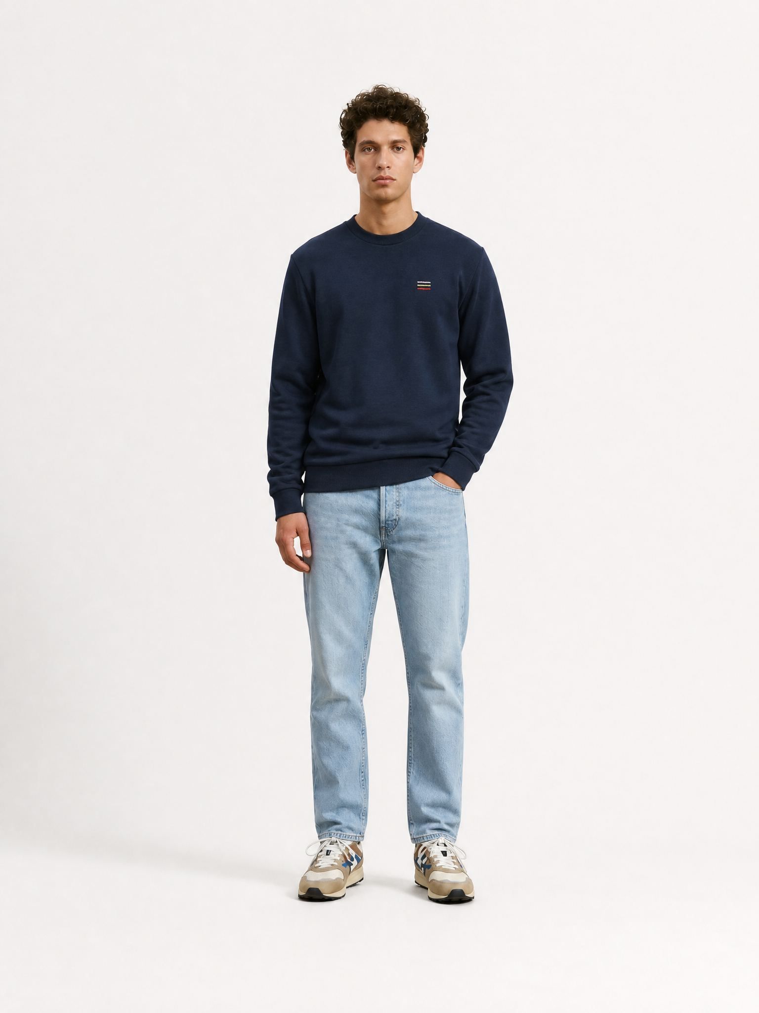 A model wearing the Grand Tours III - Embroidered Sweatshirt by La Machine Cycle Club.