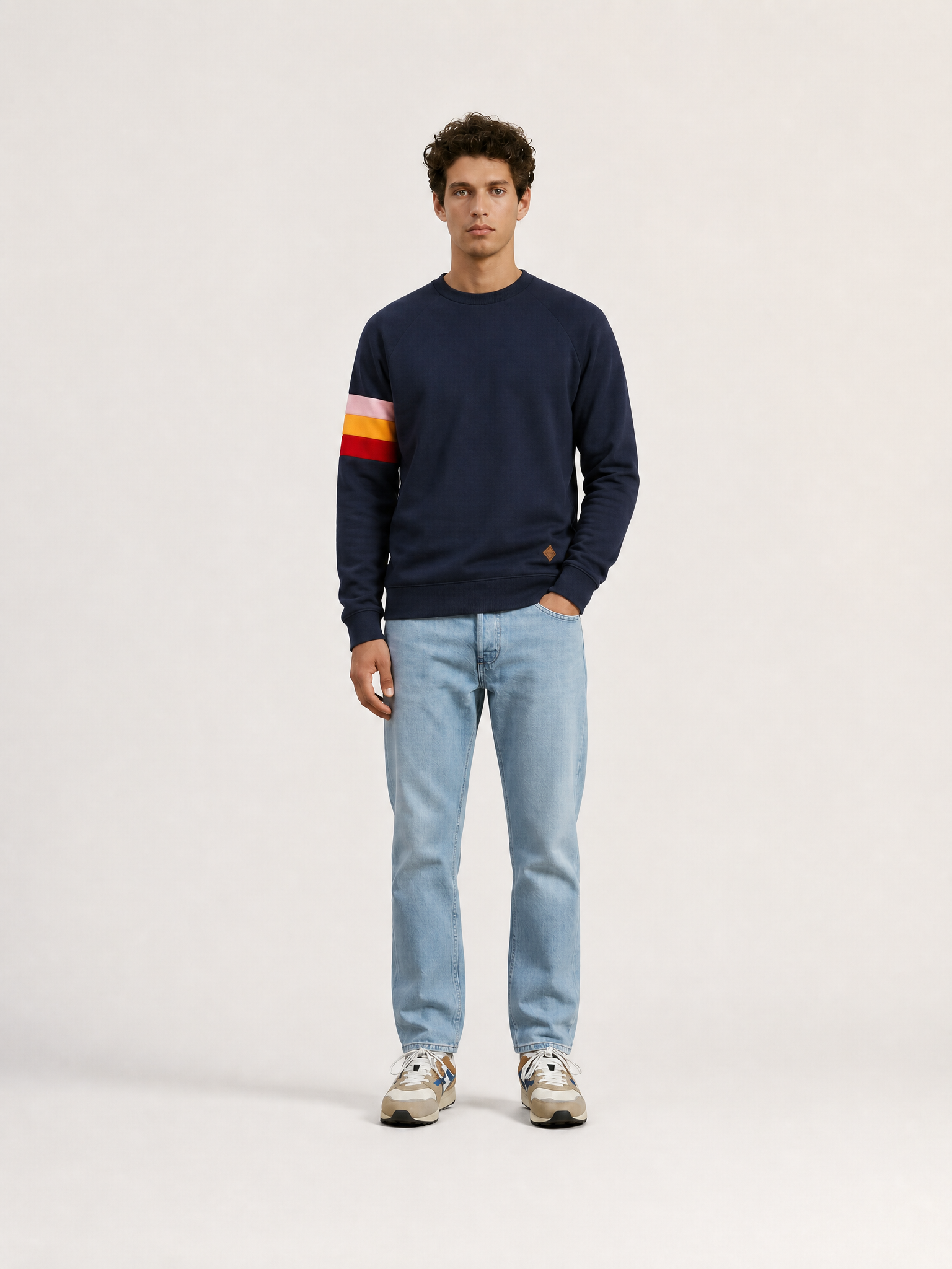 A model wearing the Grand Tours - Sweatshirt by La Machine Cycle Club.