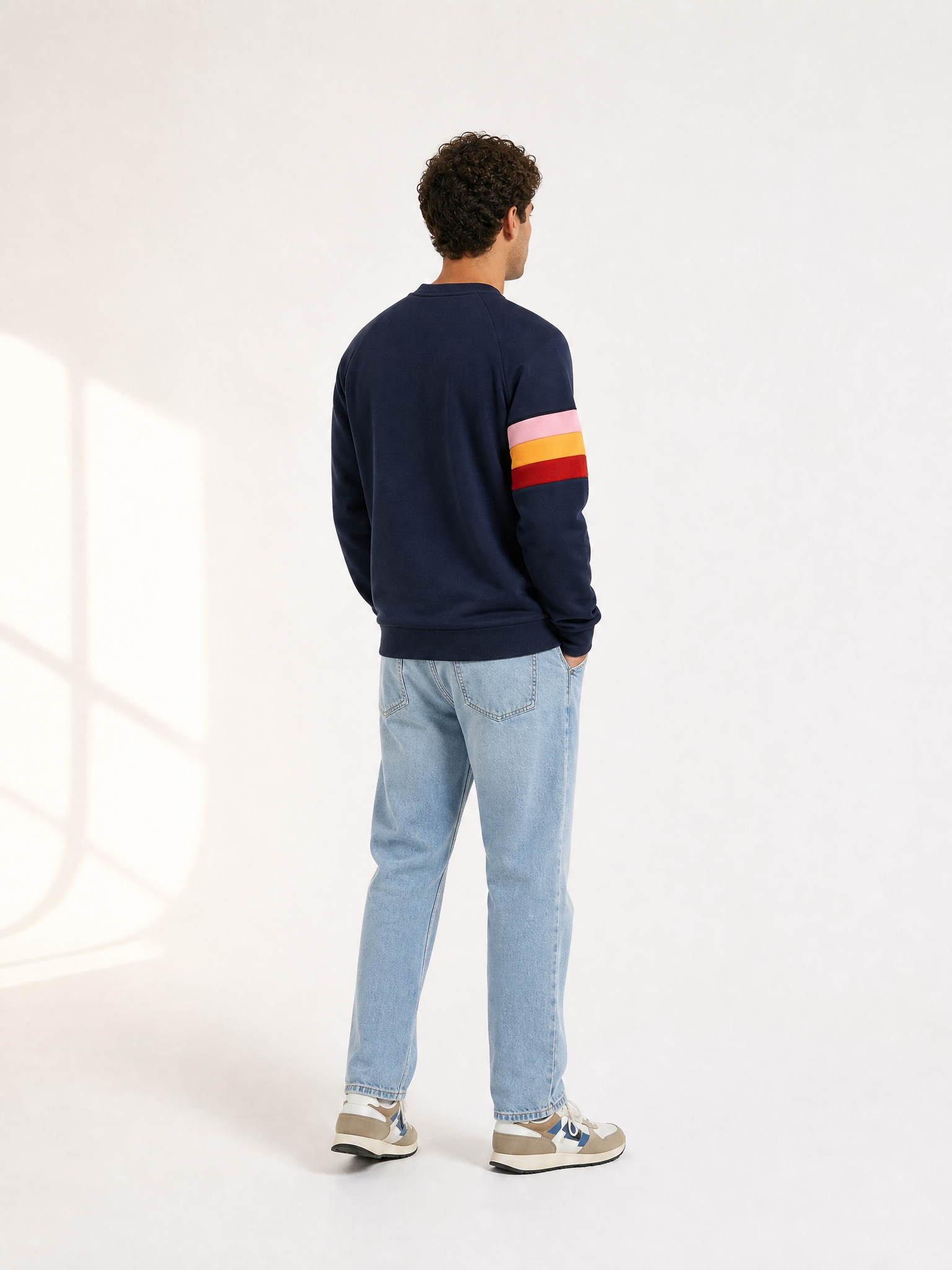 A model wearing the Grand Tours - Sweatshirt by La Machine Cycle Club.