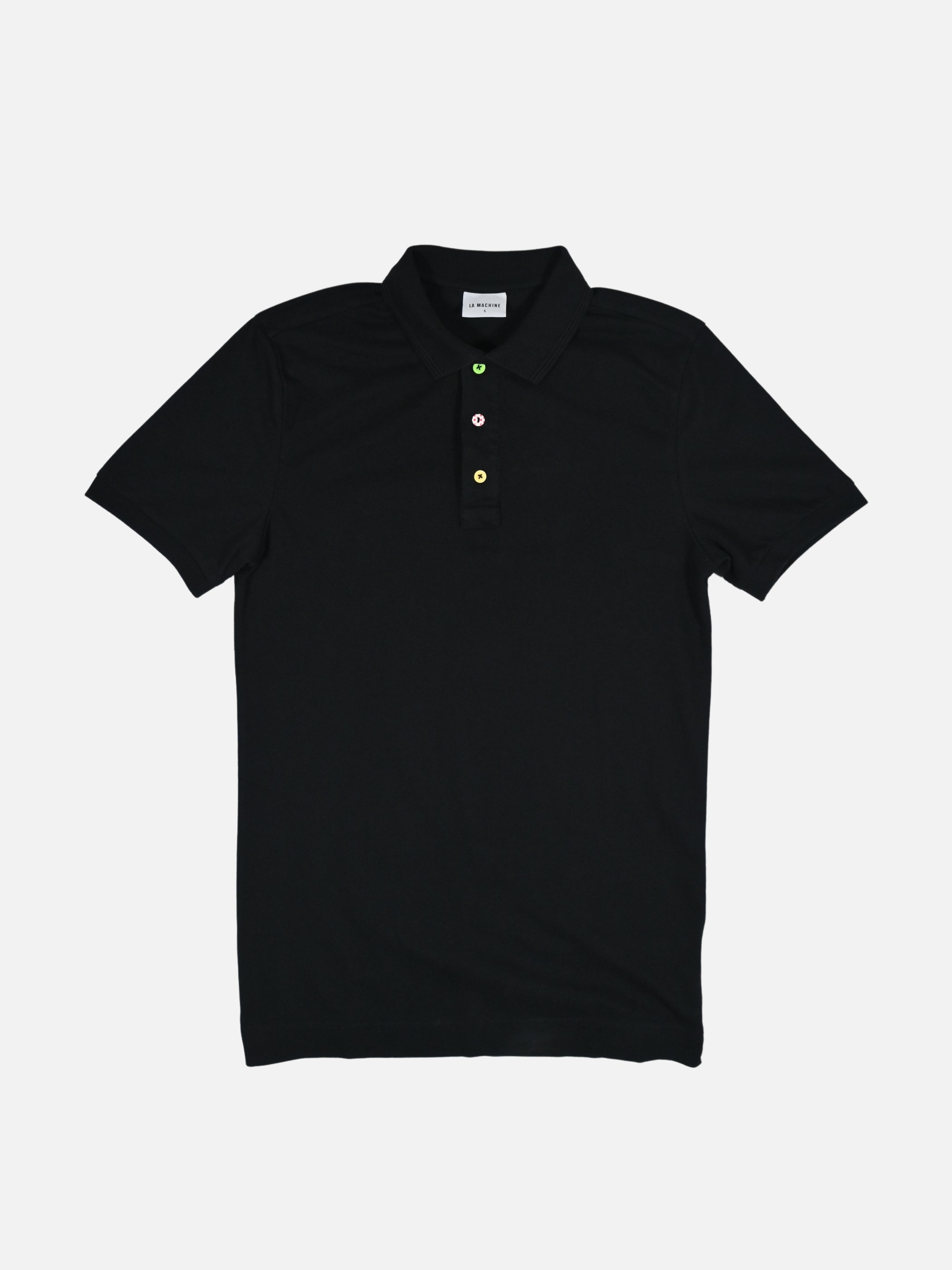 Black Grande Boucle polo shirt by La Machine with three coloured buttons inspired by the yellow, green and polka-dot jerseys of Le Grande Boucle.