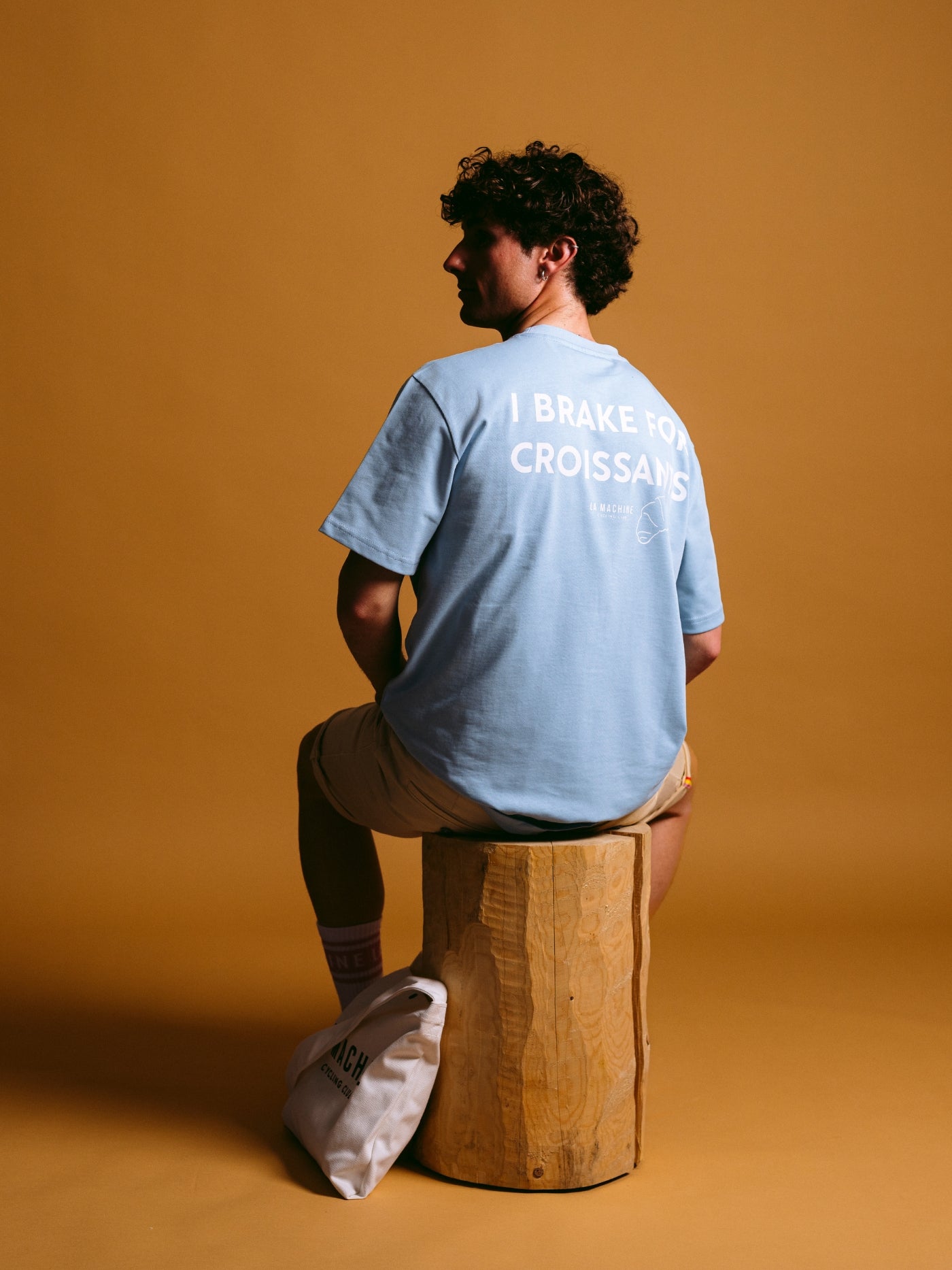 The I Brake for Croissants - Loose Fit - T-shirt - Light Blue by La Machine Cycle Club, shown from another angle.
