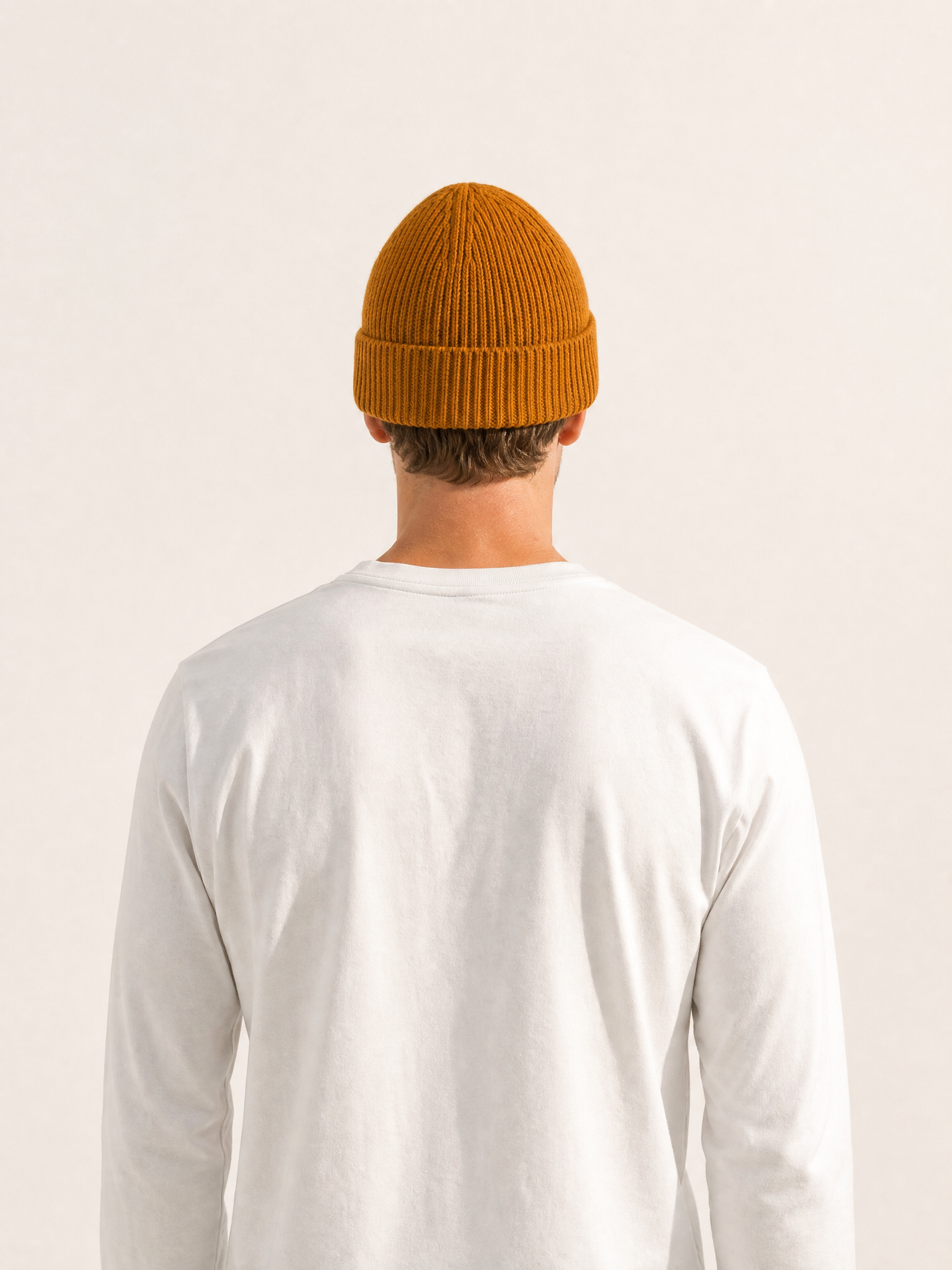 A model wearing the La Machine - Beanie - Burnt Orange by La Machine Cycle Club.