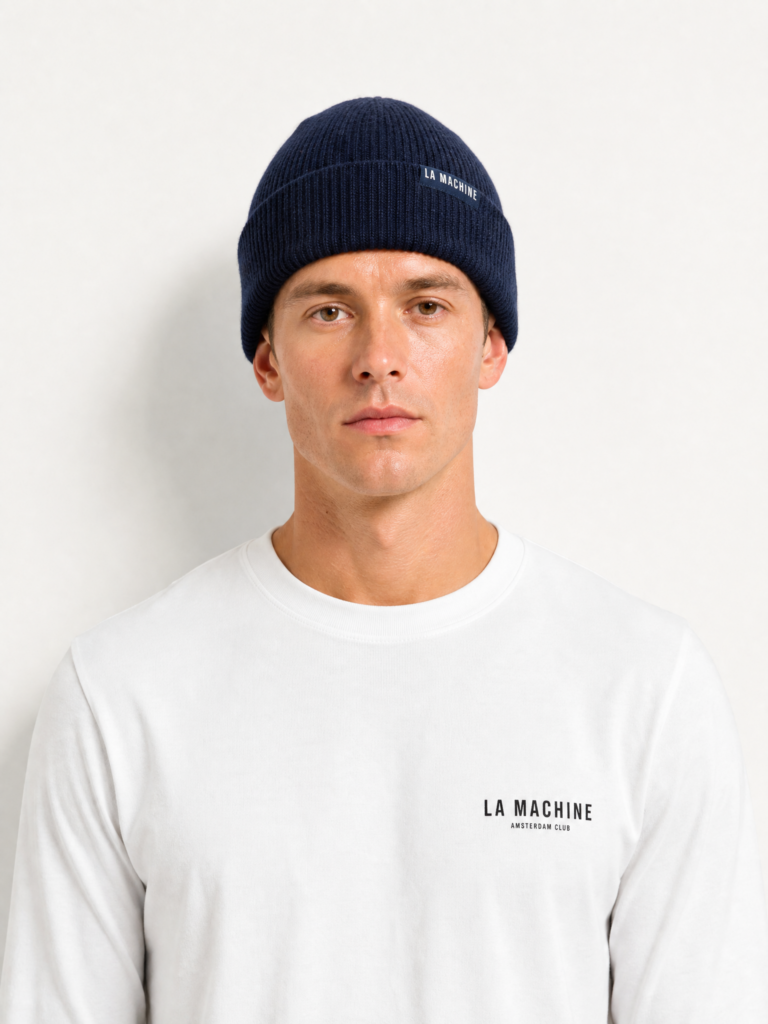 A model wearing the La Machine - Beanie - Dark Navy by La Machine Cycle Club.