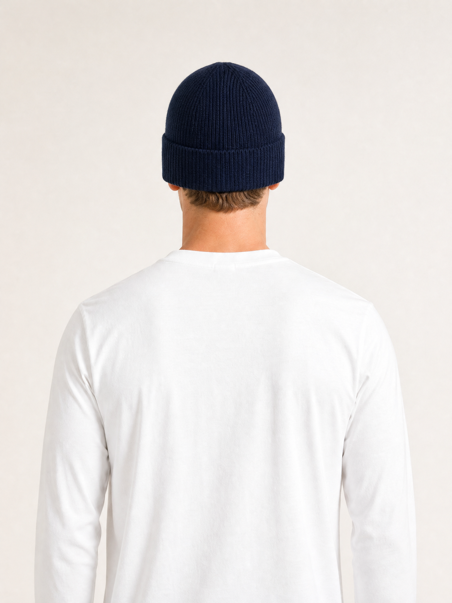 A model wearing the La Machine - Beanie - Dark Navy by La Machine Cycle Club.