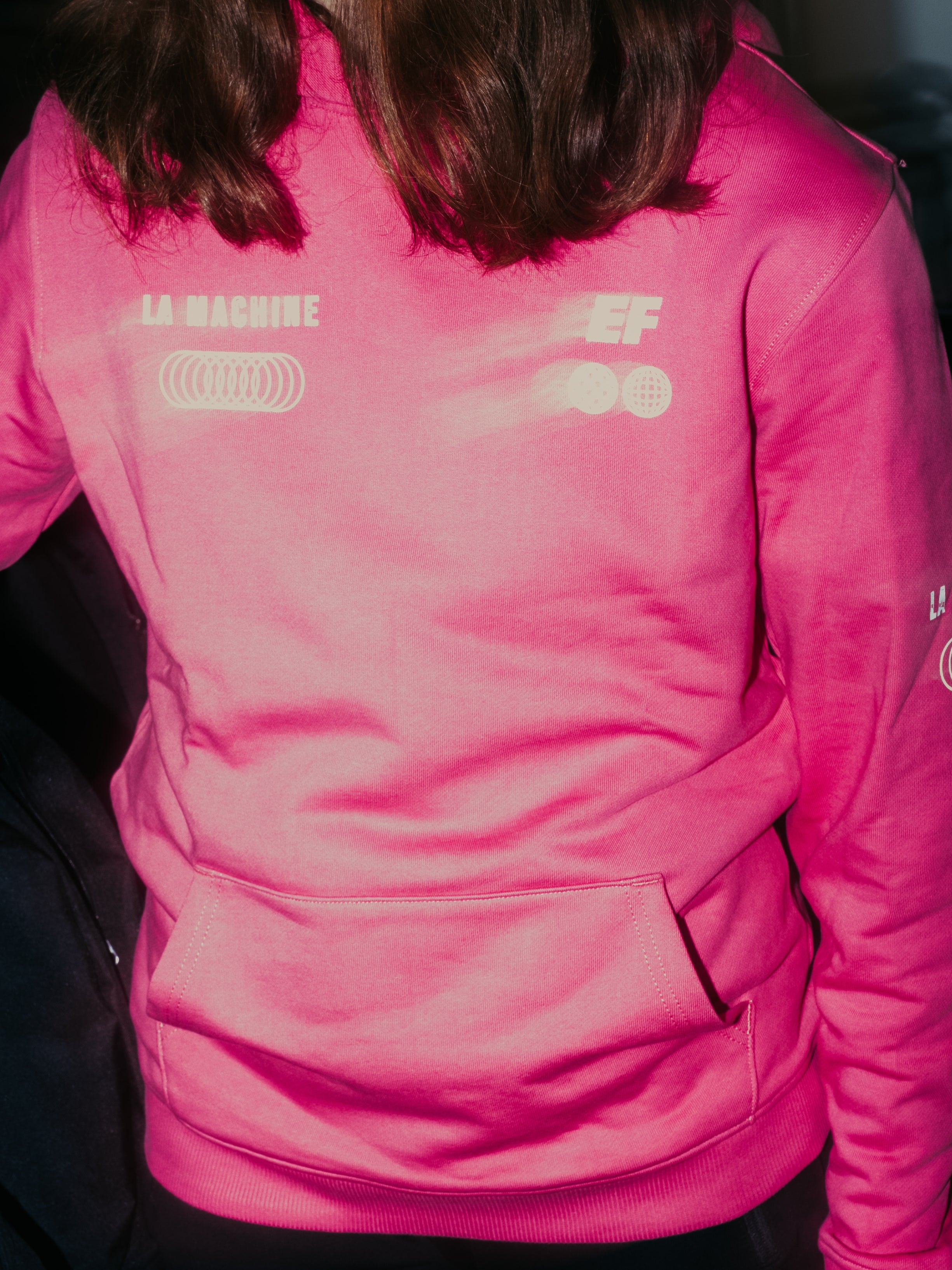 Detail view of the La Machine X EF Pro Cycling - Globe Hoodie - Pink by La Machine Cycle Club.