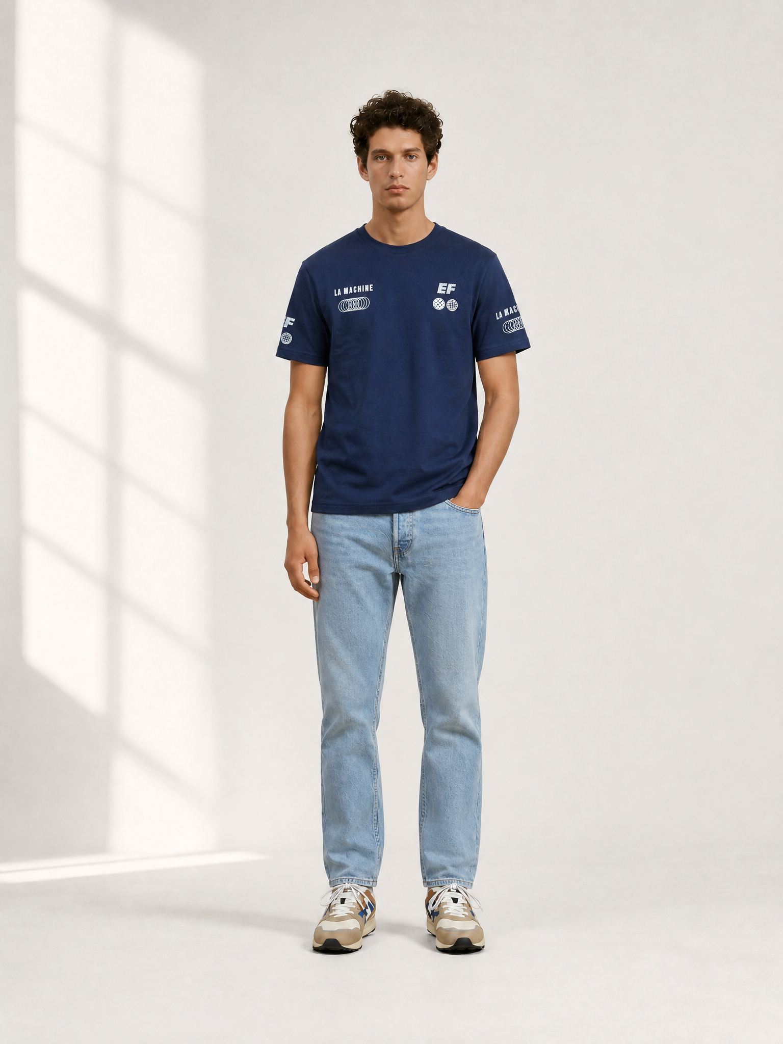 A model wearing the La Machine X EF Pro Cycling - Globe T-shirt - Dark Navy Blue by La Machine Cycle Club.