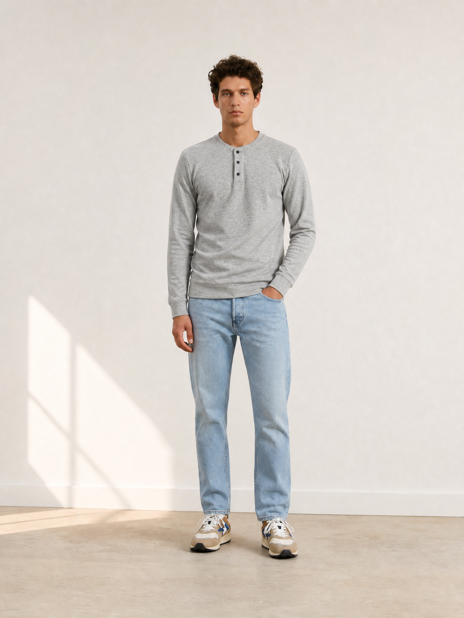 A model wearing the Le Pavé - Henley - Light Cobble Grey by La Machine Cycle Club.