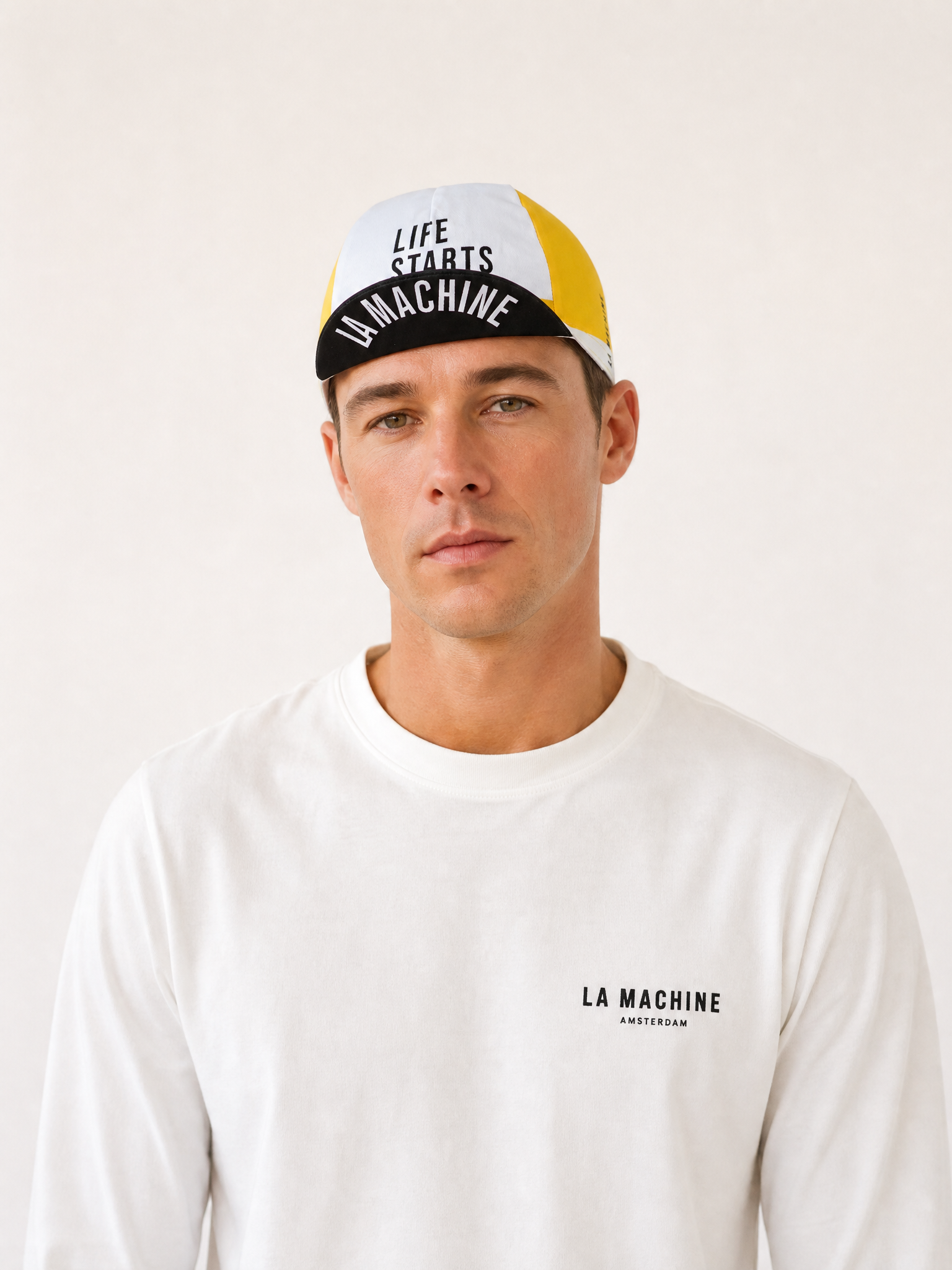 A model wearing the Life starts at 6% - Cycling Cap by La Machine Cycle Club.