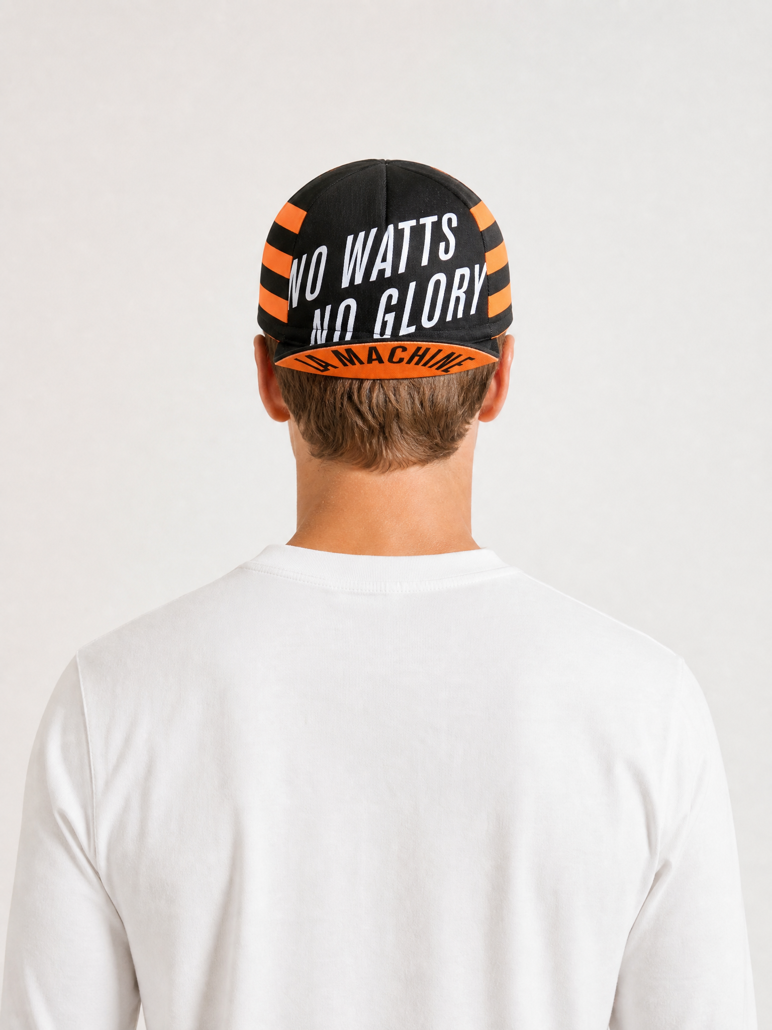 A model wearing the No Watts No Glory - Cycling Cap by La Machine Cycle Club.