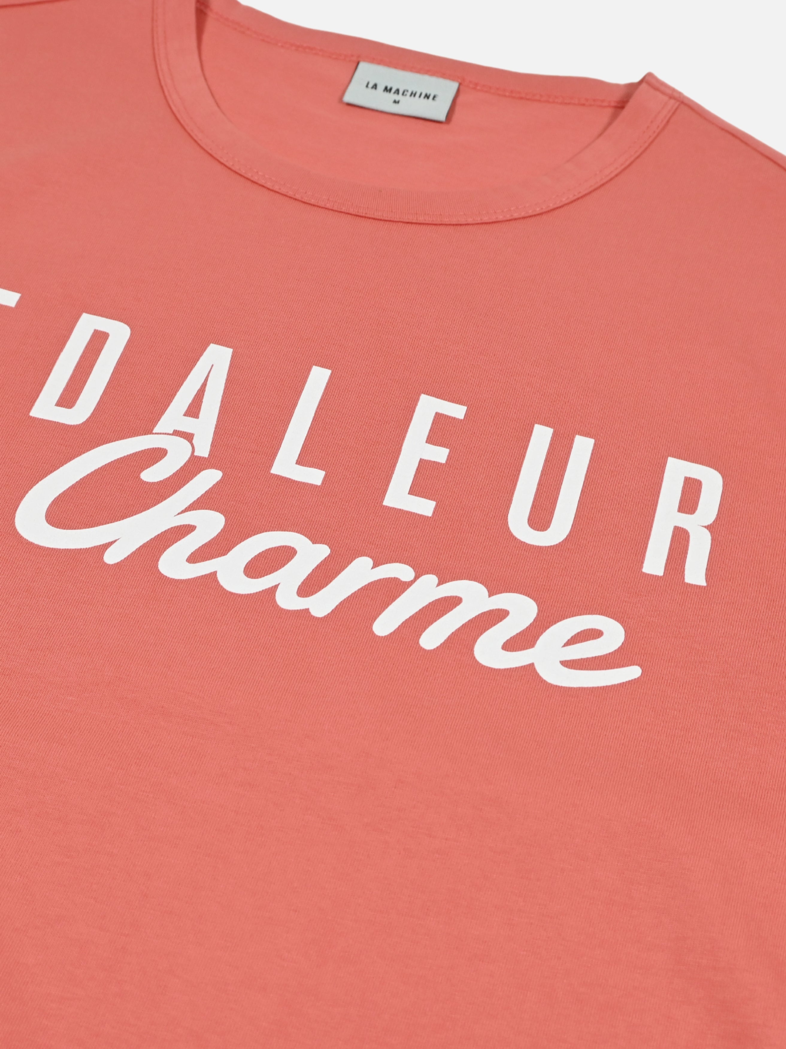 Detail view of the Pedaleur de Charme - T-shirt - Coral by La Machine Cycle Club.