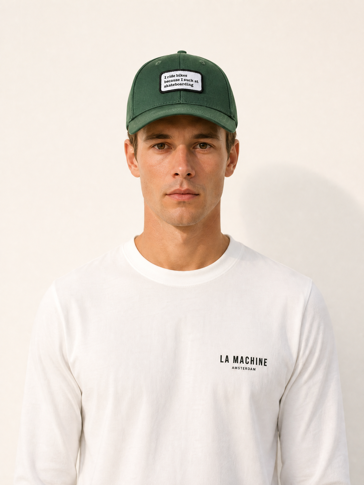 A model wearing the Suck at Skateboarding - Casual Cap by La Machine Cycle Club.