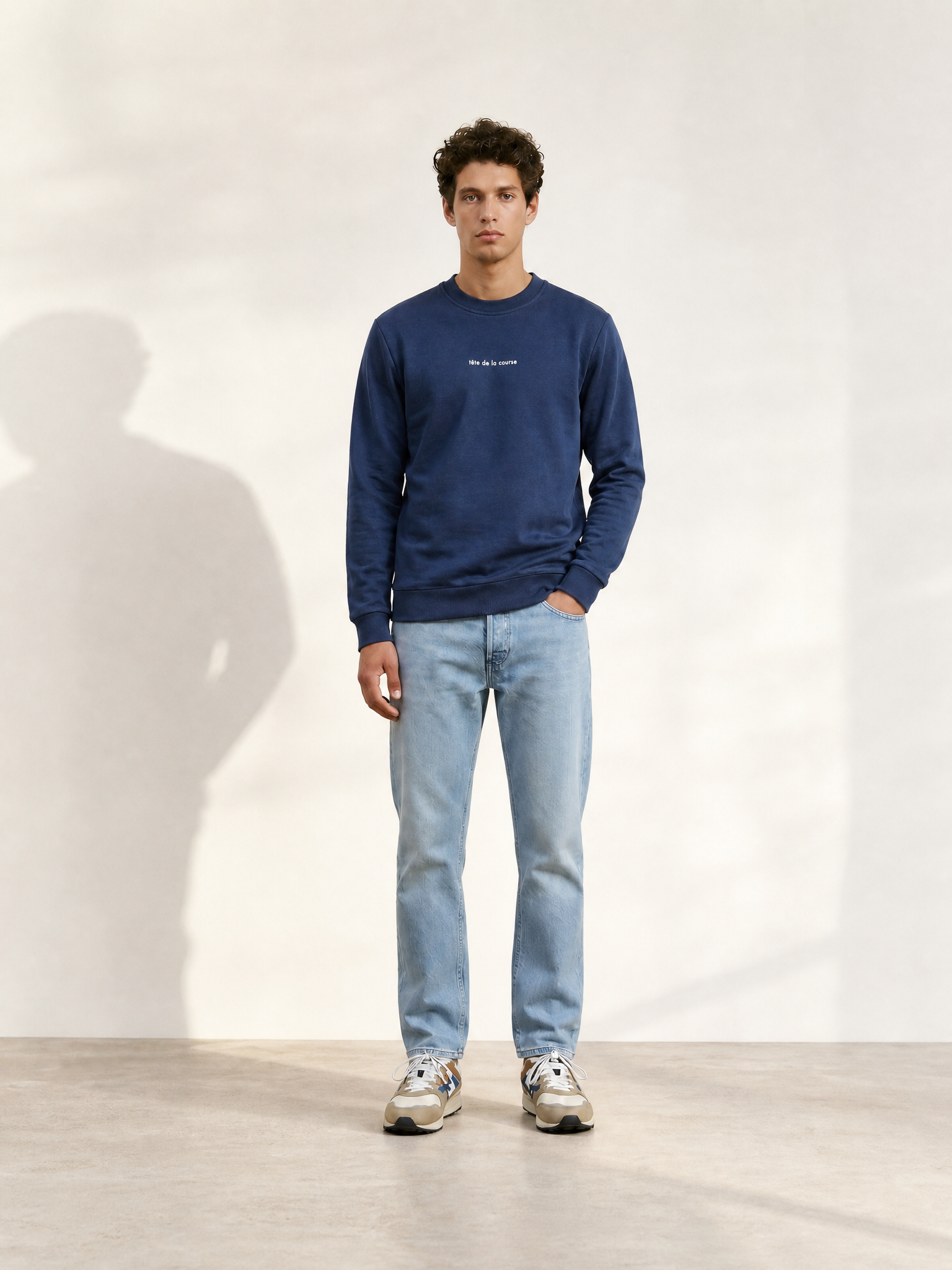A model wearing the Tête de la Course - Sweatshirt by La Machine Cycle Club.
