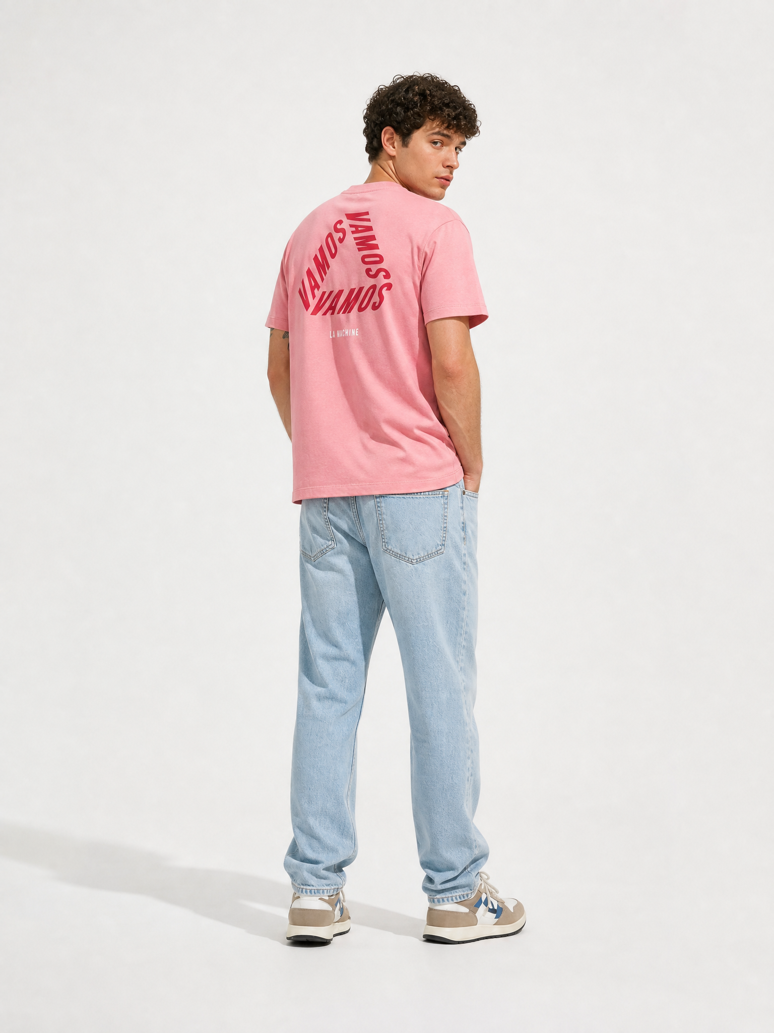 A model wearing the Vamos - Loose Fit - Vuelta a España T-shirt by La Machine Cycle Club.